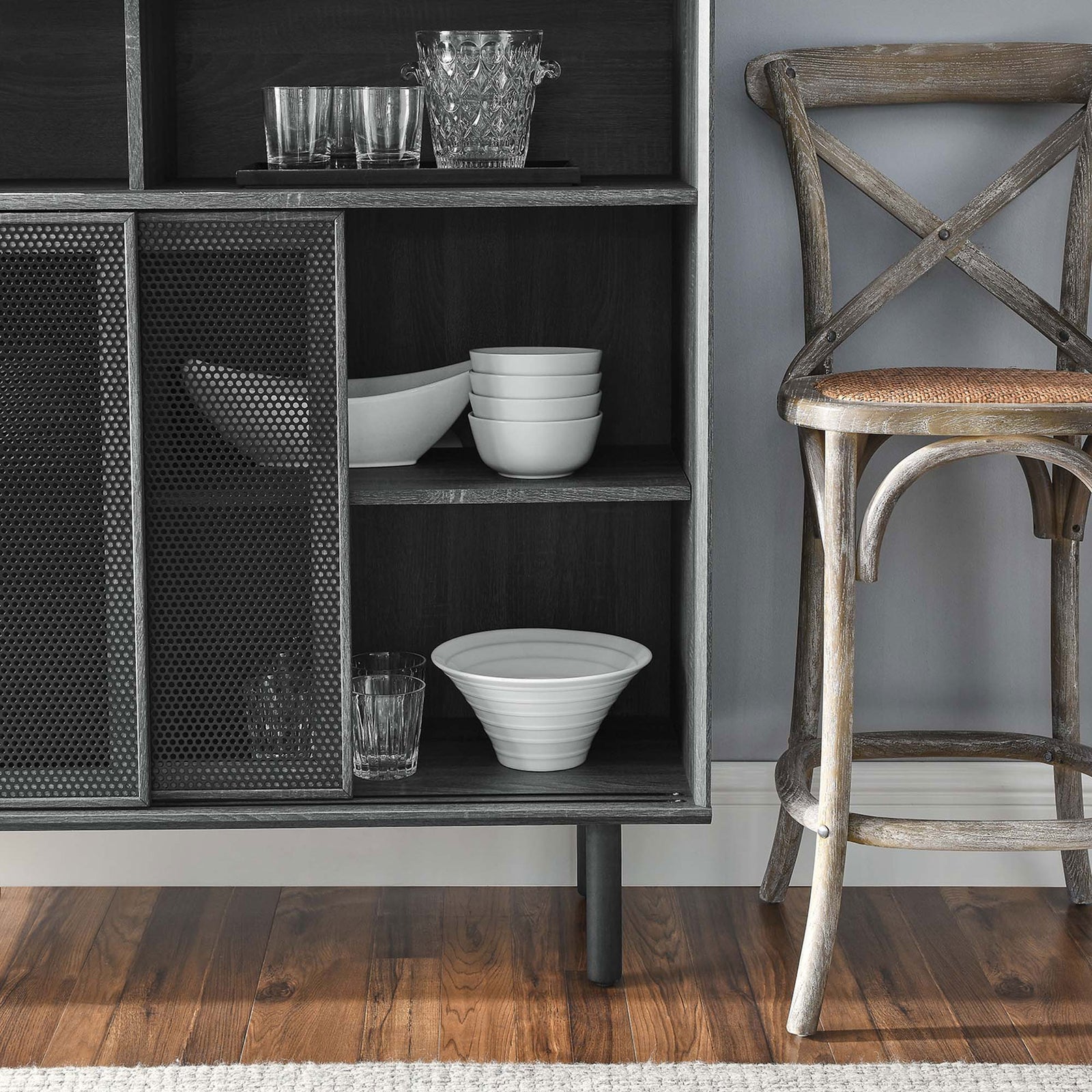 Charcoal cabinet shelves neatly organize dishes and glassware while mesh doors frame the contents with subtle texture. || EEI-6237-CHA || detail_room