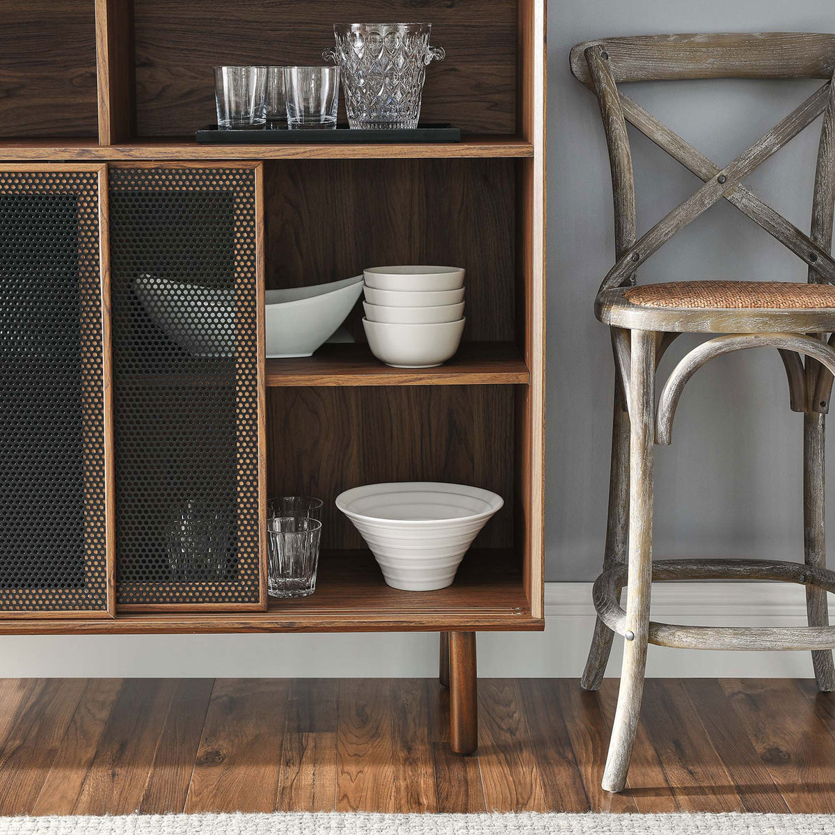 Walnut shelves organize everyday dishes while dark mesh doors lend depth and pattern to the storage area. || EEI-6237-WAL || detail_room