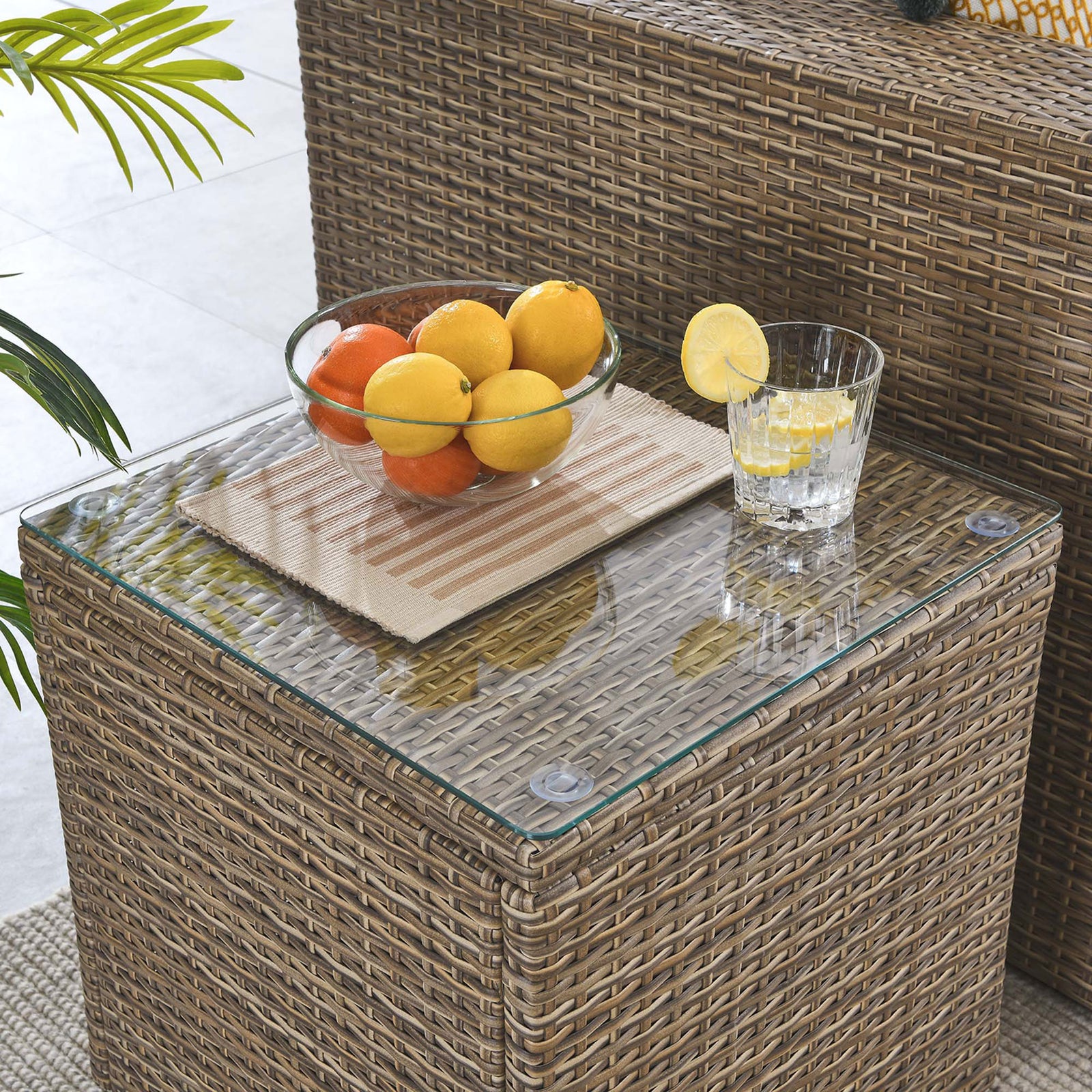 Outdoor rattan side table with glass top styled with fruit bowl and refreshment || EEI-6240 || front_angle_room