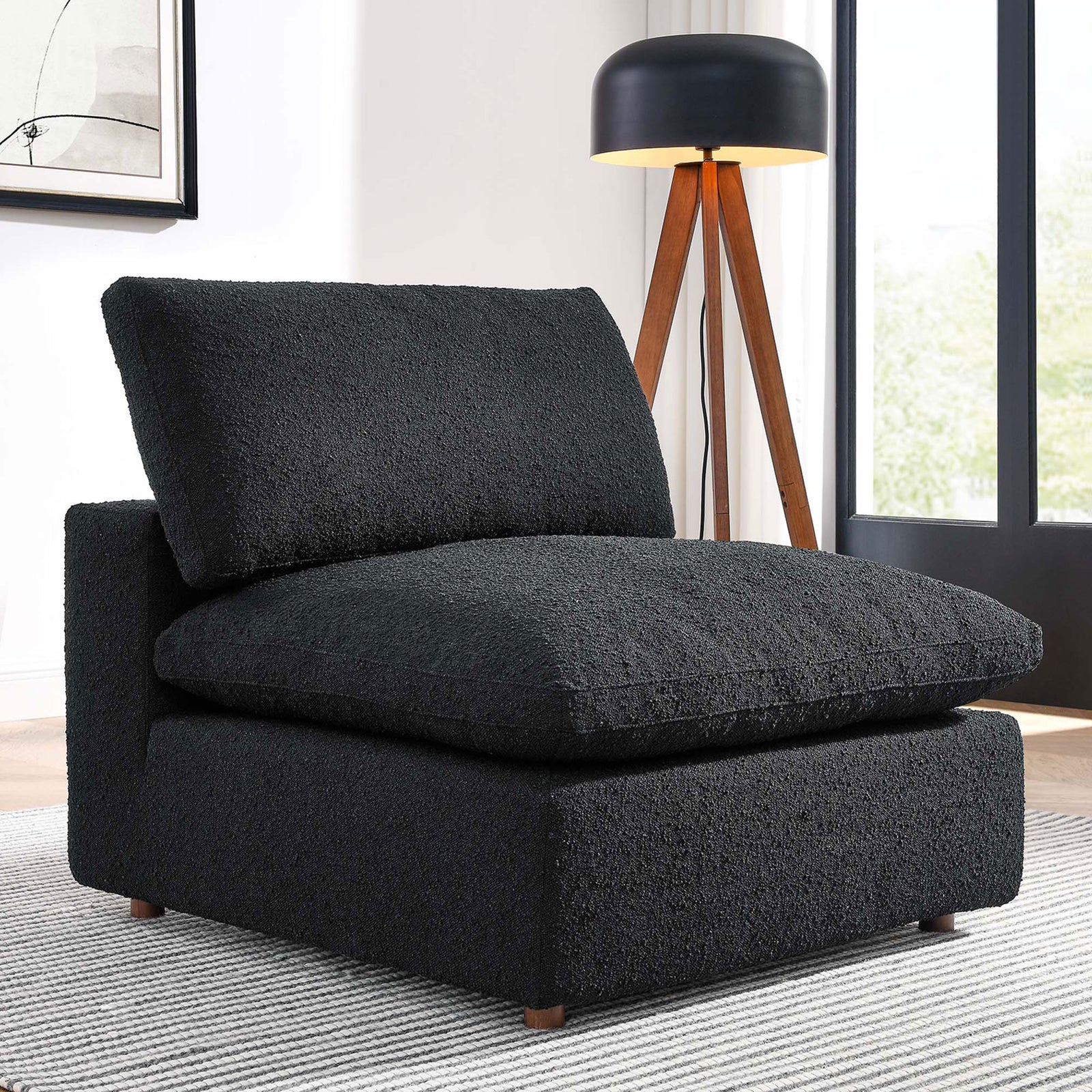 Cozy black boucle armless chair anchors a modern lounge-ready living space || EEI-6257-BLK || front_angle_room