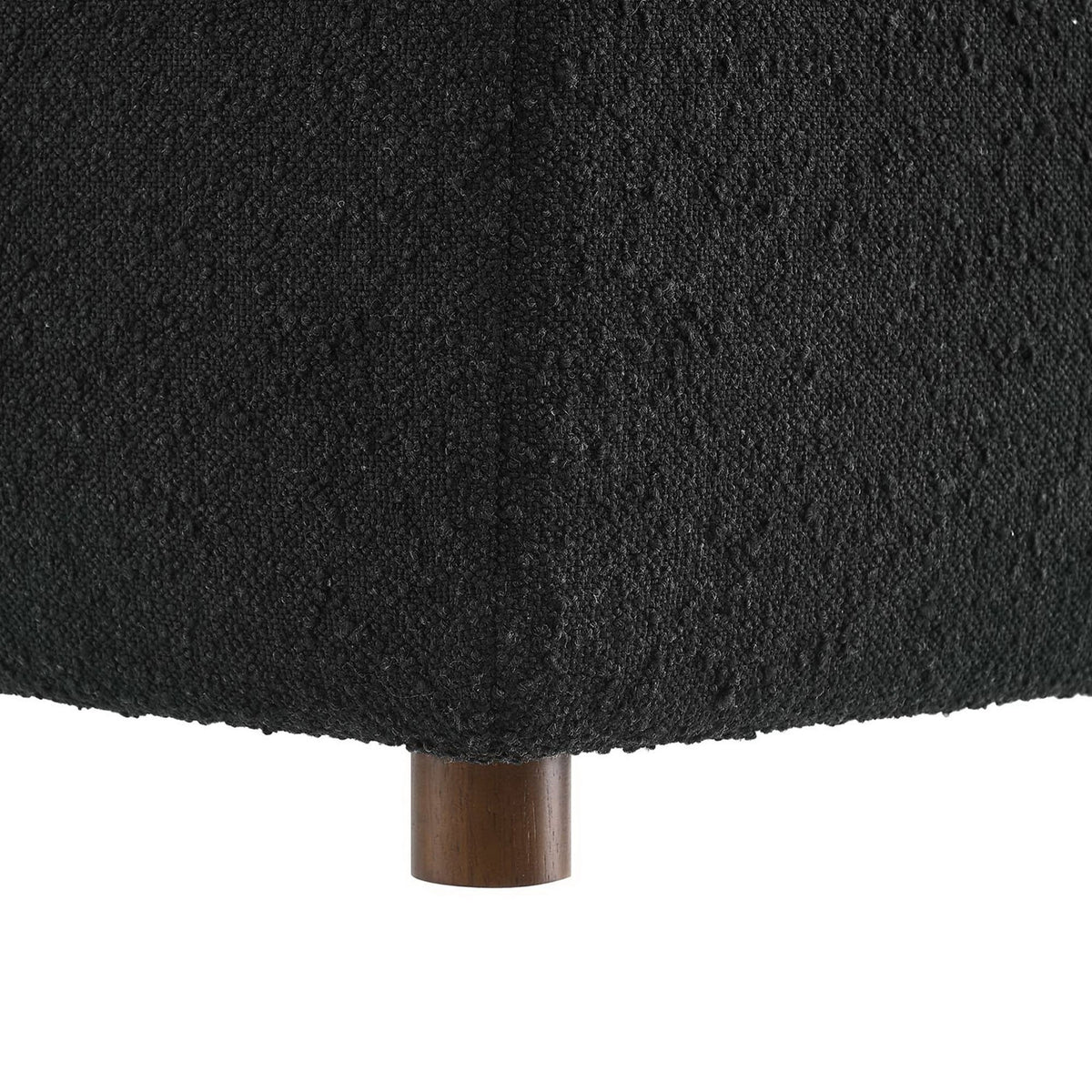 Black boucle upholstery and round wooden legs give this ottoman a modern, grounded look || EEI-6258-BLK || leg_studio