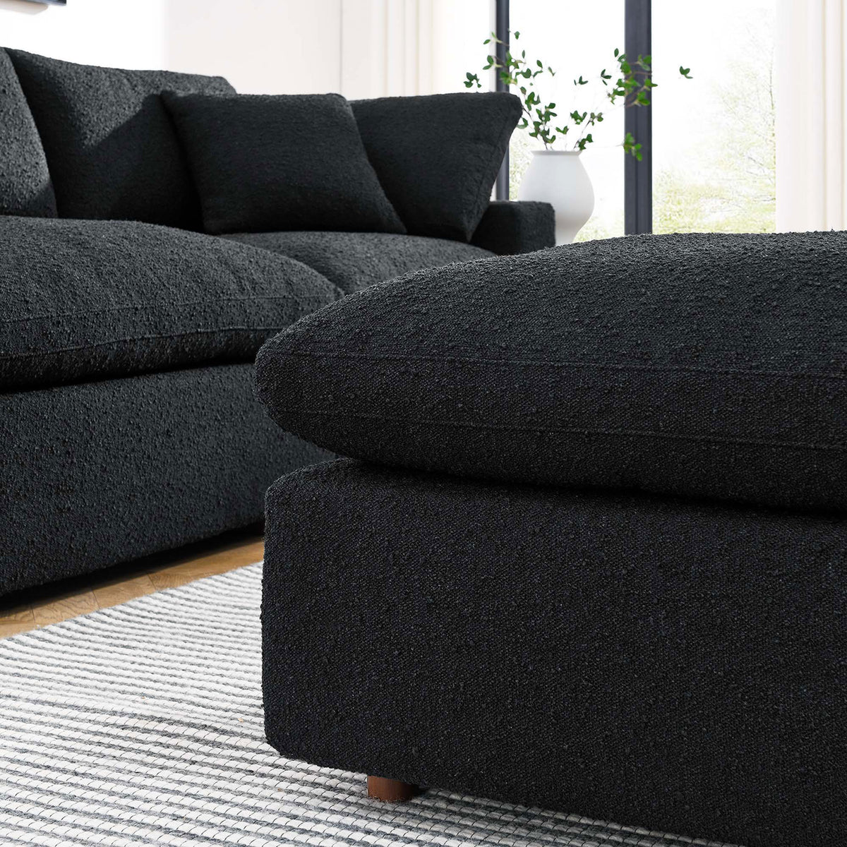Black boucle ottoman pairs with matching sectional to create a cozy, modern living room seating nook || EEI-6258-BLK || detail_room