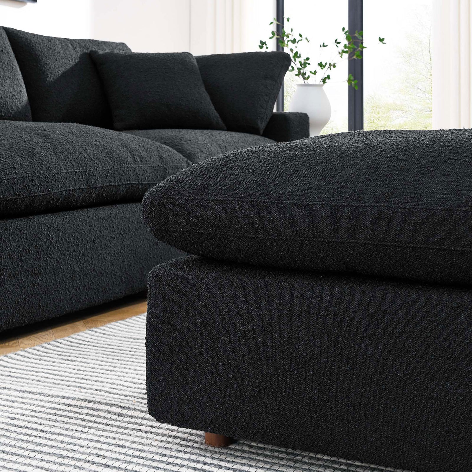 Black boucle ottoman pairs with matching sectional to create a cozy, modern living room seating nook || EEI-6258-BLK || detail_room