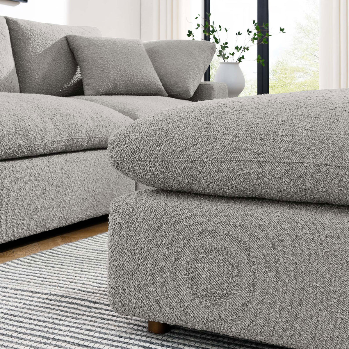 Coordinating Commix sectional and ottoman in light gray boucle create an inviting, cloud-like lounge area || EEI-6258-LGR || front_angle_room