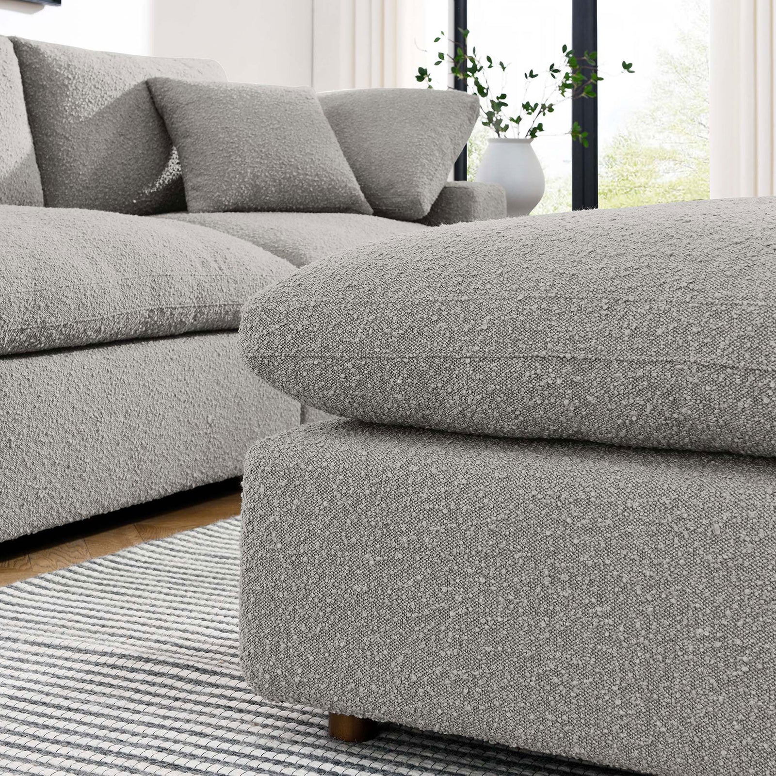 Coordinating Commix sectional and ottoman in light gray boucle create an inviting, cloud-like lounge area || EEI-6258-LGR || front_angle_room