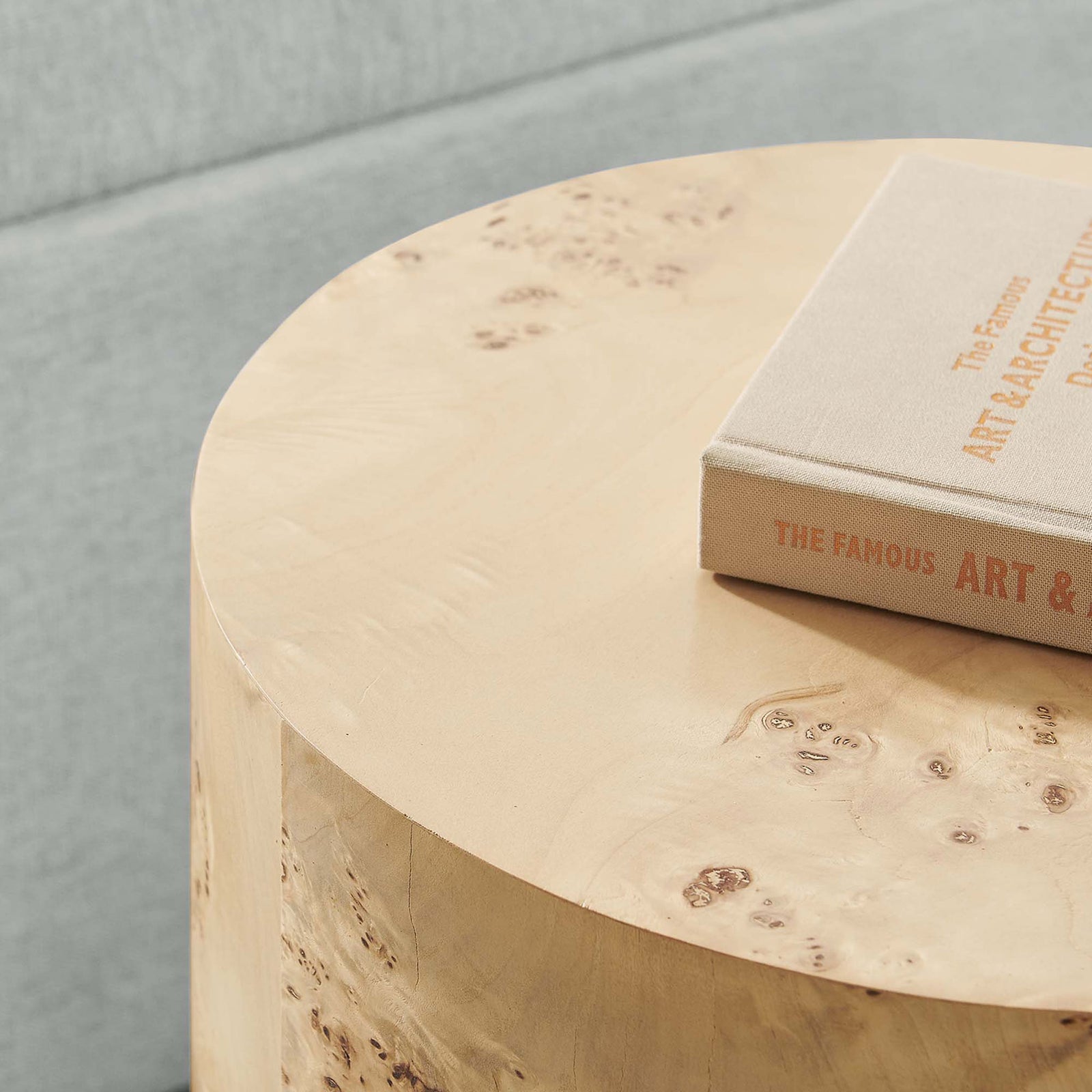 Round burl wood tabletop styled with a book to showcase smooth surface and natural grain. || EEI-6271-NAB || detail_room