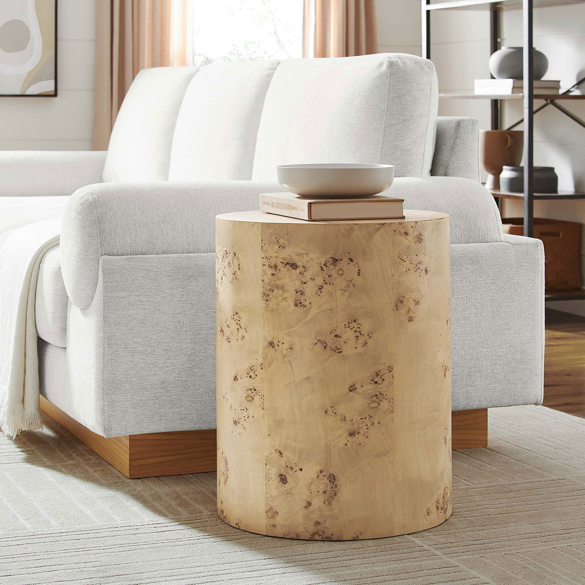 Natural burl wood side table beside a modern sofa, adding organic warmth to a cozy living room. || EEI-6271-NAB || front_angle_room