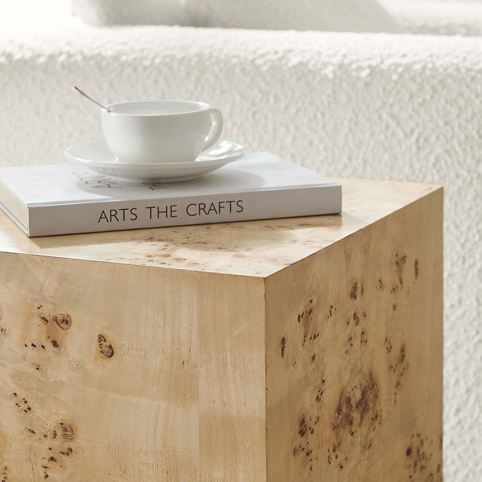 Cosmos burl wood side table styled with a book and cup on its smooth top, perfect beside a cozy sofa || EEI-6273-NAB || detail_room