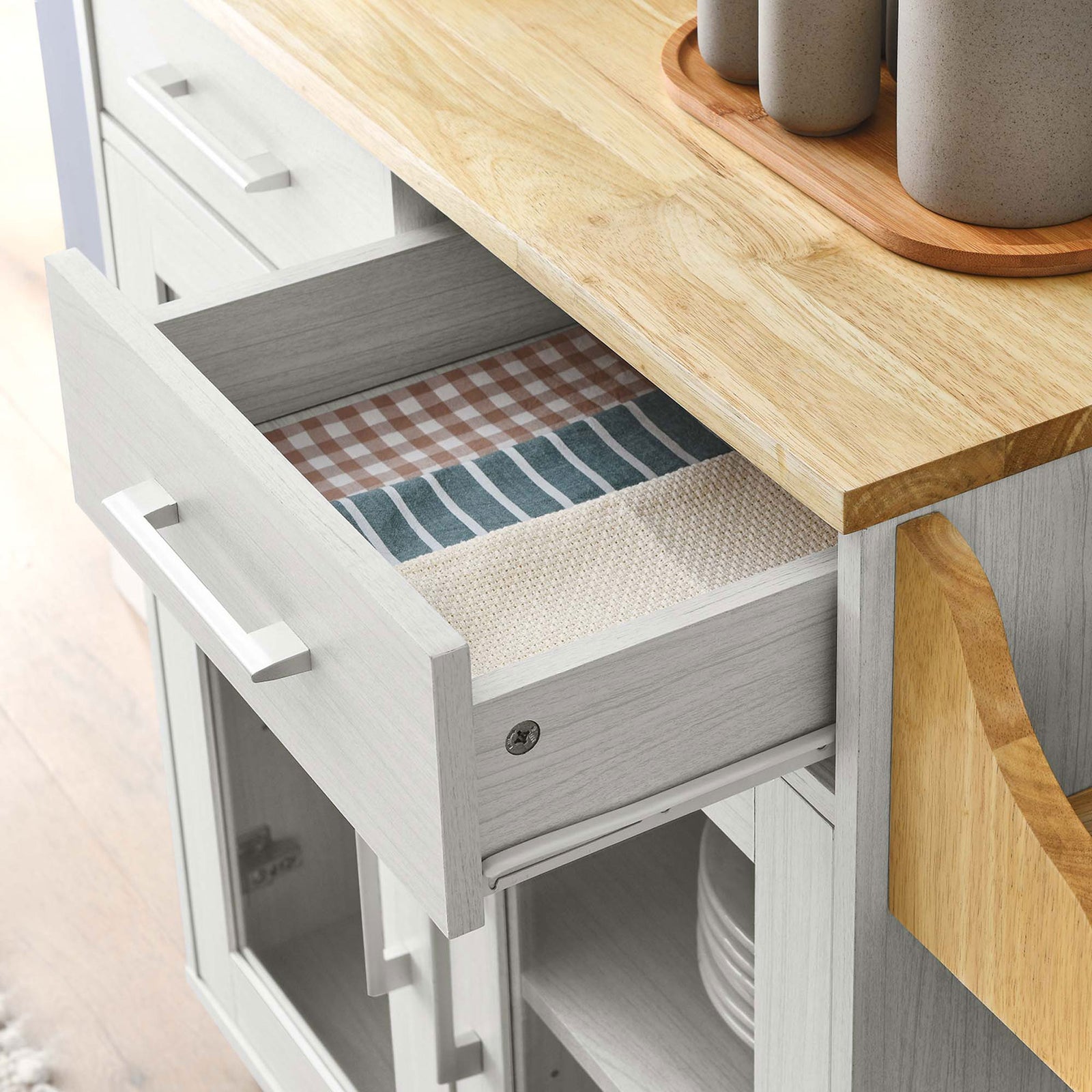 Open drawer on the kitchen cart showcasing neatly folded linens and everyday dining essentials || EEI-6276-WHI-NAT || storage_open_room