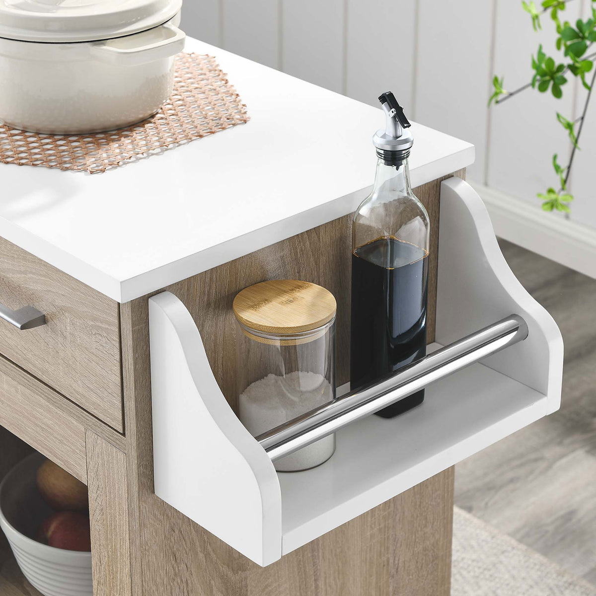 Kitchen cart spice rack stocked with oils and canister accents beside a bright window and greenery || EEI-6277-OAK-WHI || storage_room