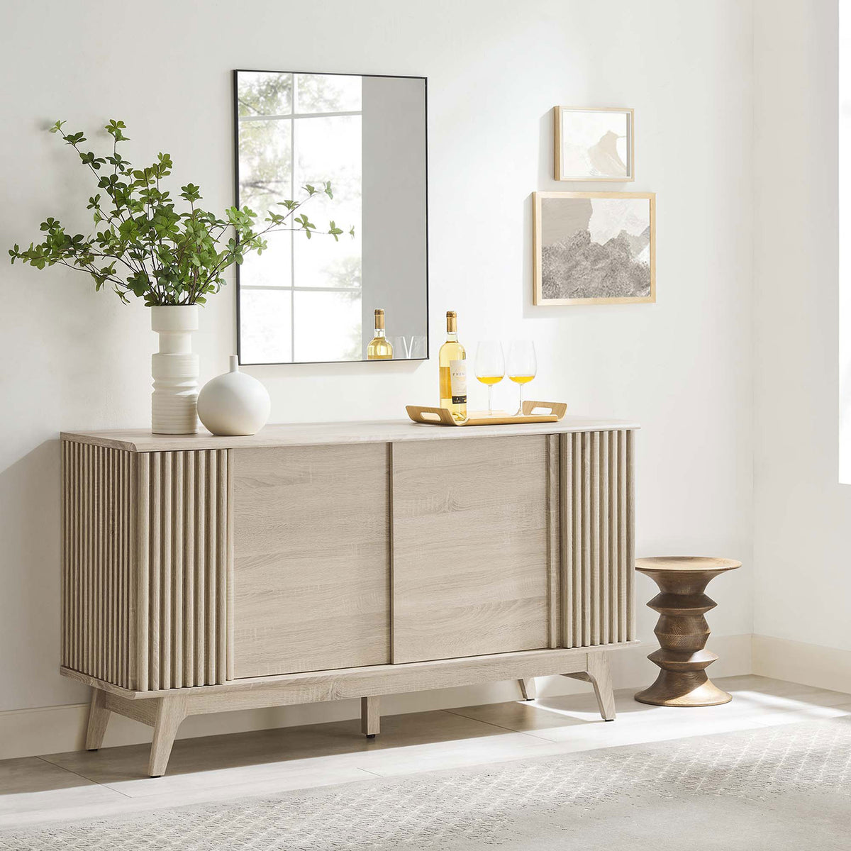 Oak sideboard styled in modern living space with decor accents and wall art || EEI-6278-OAK || front_angle_room