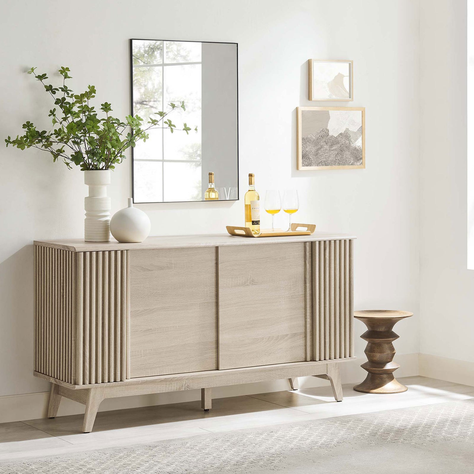 Oak sideboard styled in modern living space with decor accents and wall art || EEI-6278-OAK || front_angle_room