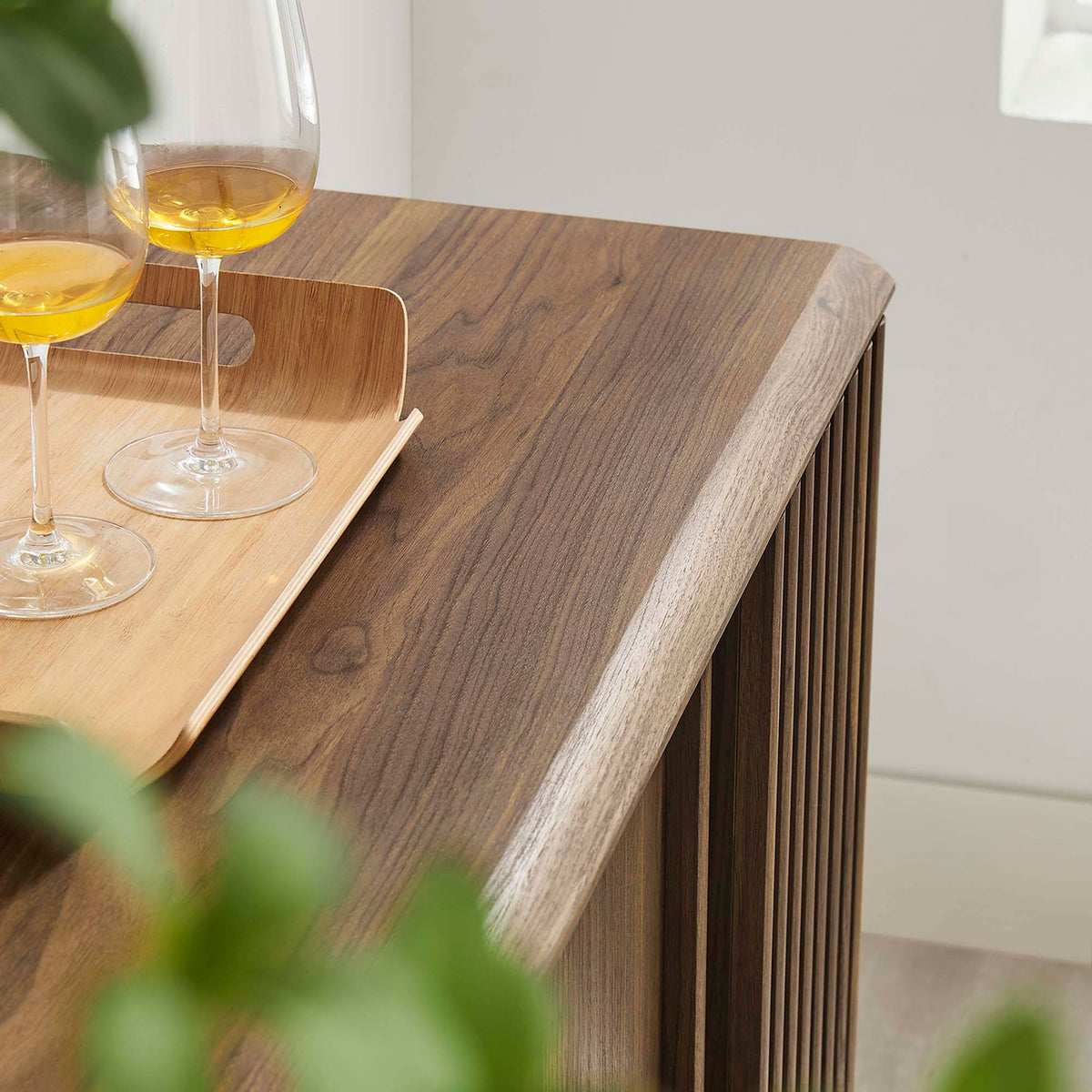 Styled walnut sideboard top with tray and glasses adds a warm, inviting touch to modern living or dining spaces. || EEI-6278-WAL || detail_room