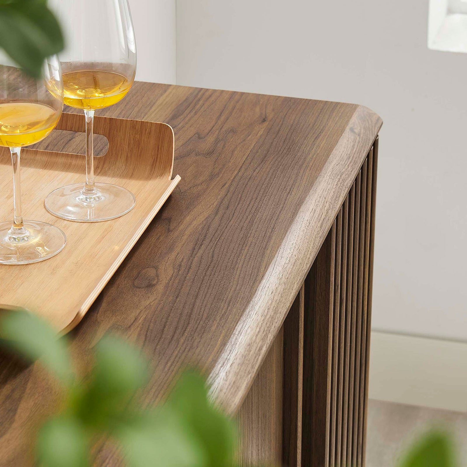 Styled walnut sideboard top with tray and glasses adds a warm, inviting touch to modern living or dining spaces. || EEI-6278-WAL || detail_room