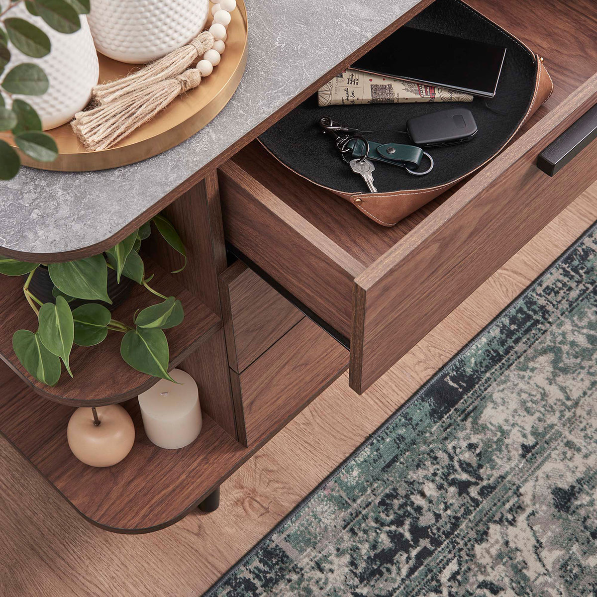 Open drawer and side shelf of the Langston sideboard storing everyday essentials and decorative accents. || EEI-6281-WAL-GRY || storage_open_room