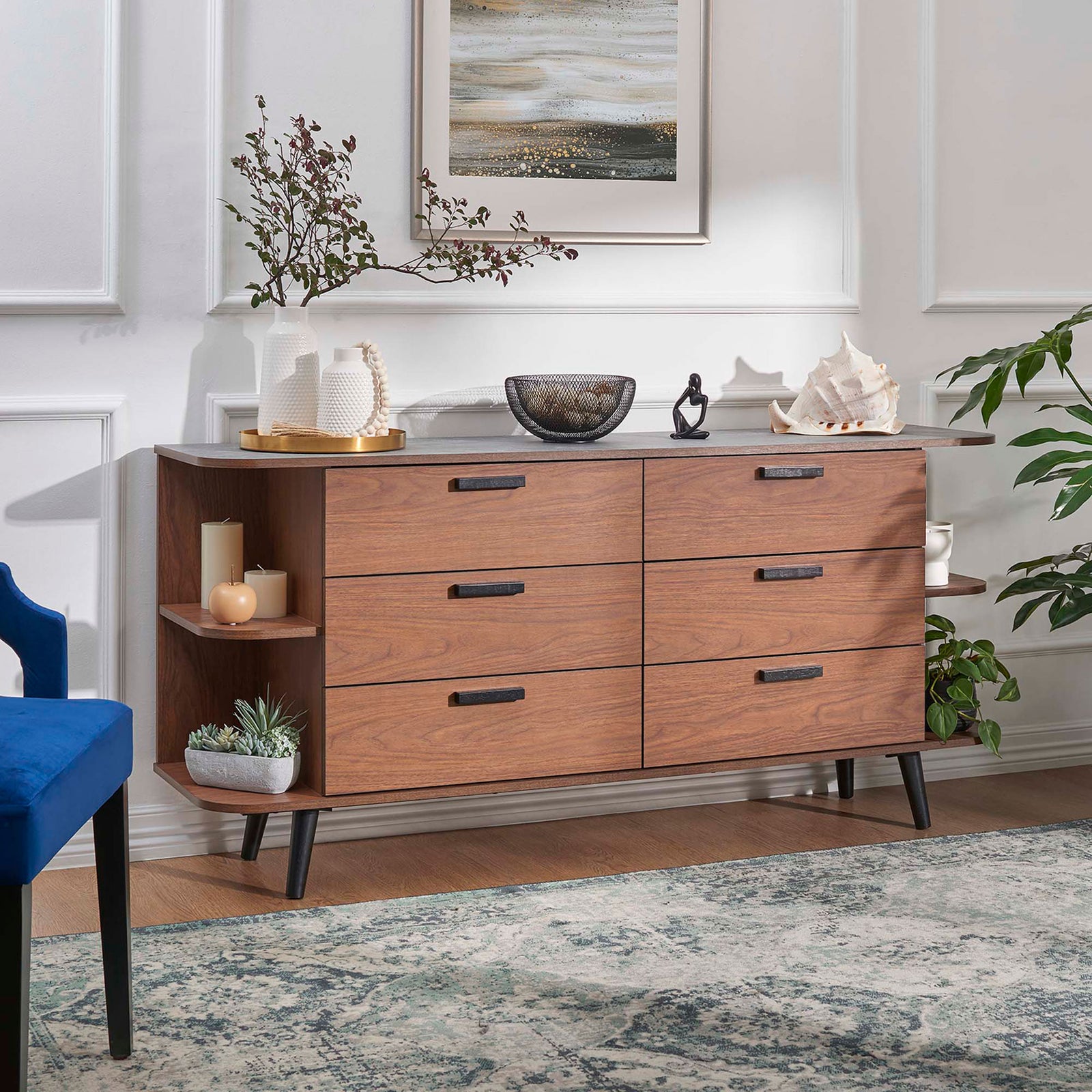 Langston walnut gray sideboard styled with decor in a bright living room for versatile storage and display. || EEI-6281-WAL-GRY || front_angle_room