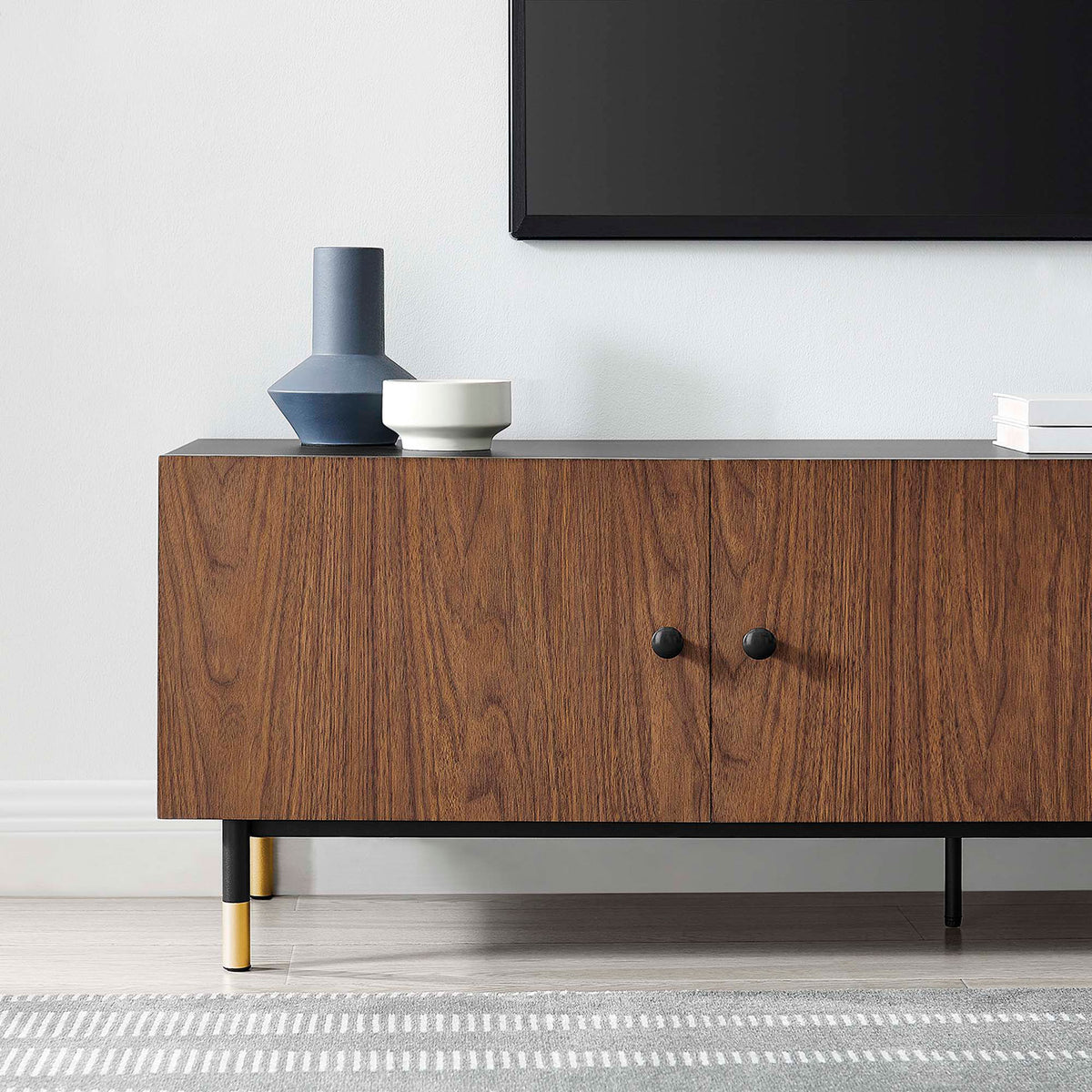 Styled close up of Nexus TV stand in a living room with decor and rug || EEI-6282-BLK-WAL || detail_room