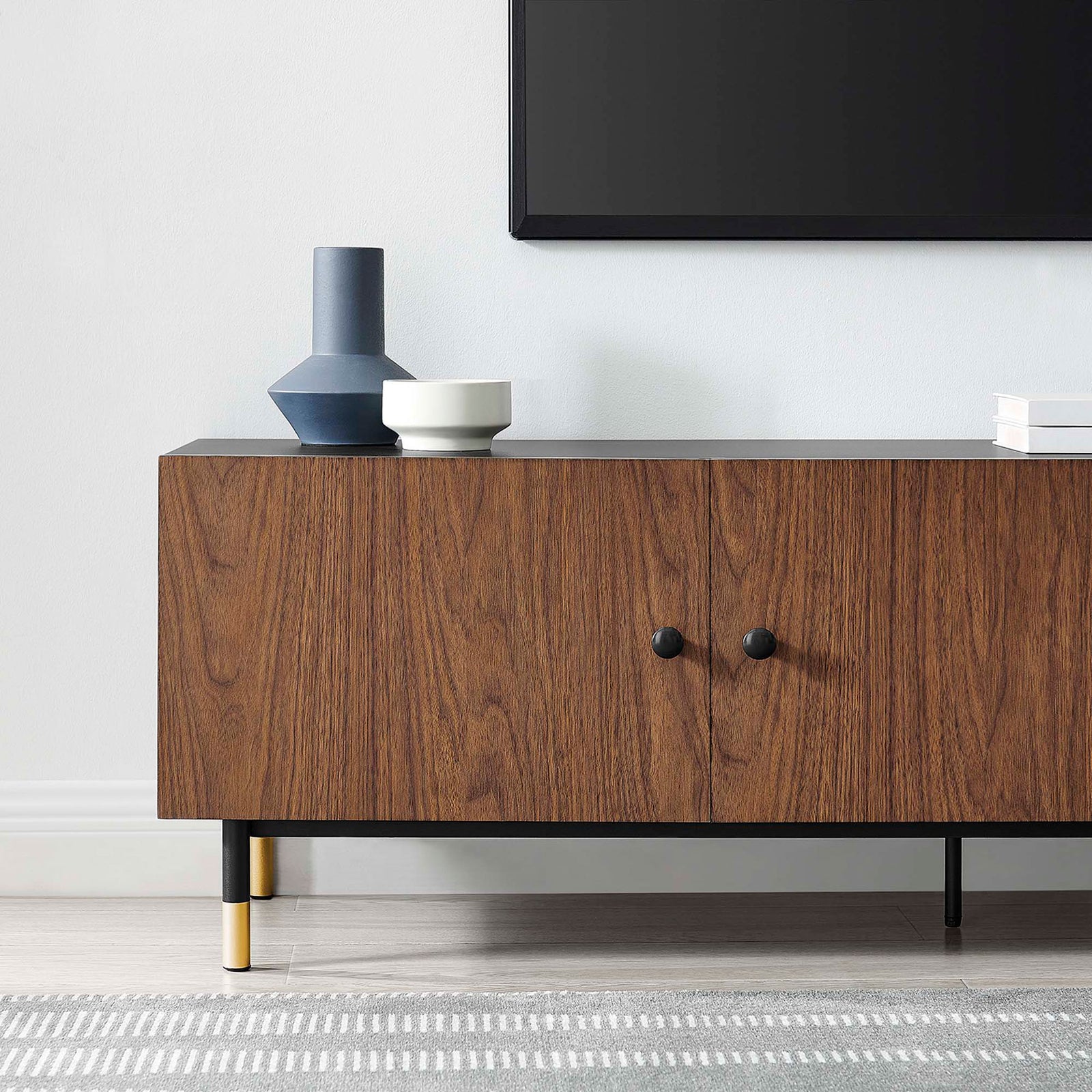 Styled close up of Nexus TV stand in a living room with decor and rug || EEI-6282-BLK-WAL || detail_room