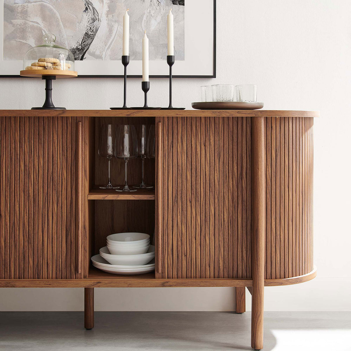 Styled walnut sideboard vignette with dinnerware and glassware, adding warmth to a modern dining space || EEI-6309-WAL || detail_room