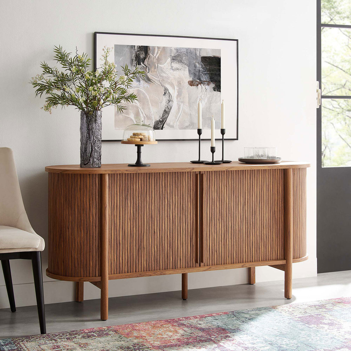 Walnut fluted sideboard styled with artwork, greenery, and desserts for an inviting entryway look || EEI-6309-WAL || front_angle_room