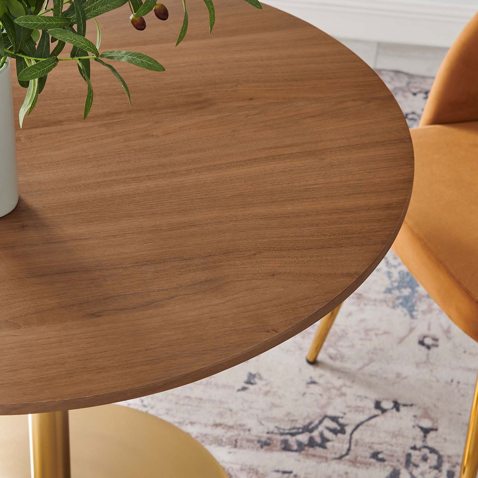 Walnut tabletop styled with greenery and warm accent chair legs adds cozy mid-century charm to your dining area || EEI-6313-WAL-GLD || detail_room