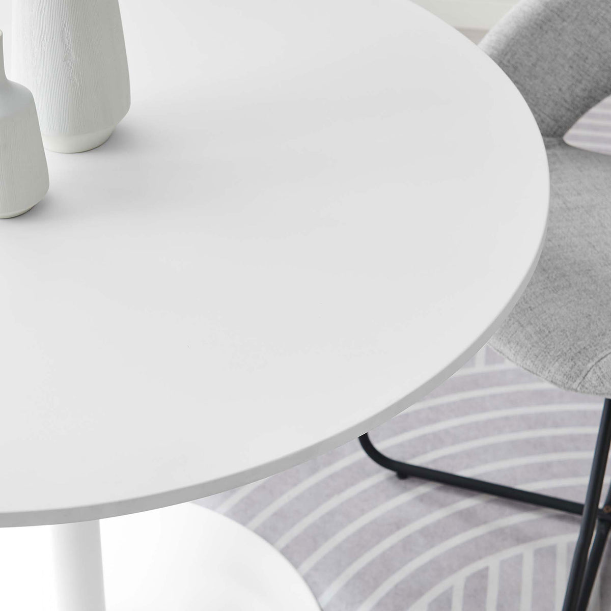 Detailed look at the white round tabletop styled with decor to showcase the smooth finish and inviting feel || EEI-6313-WHI-WHI || detail_room