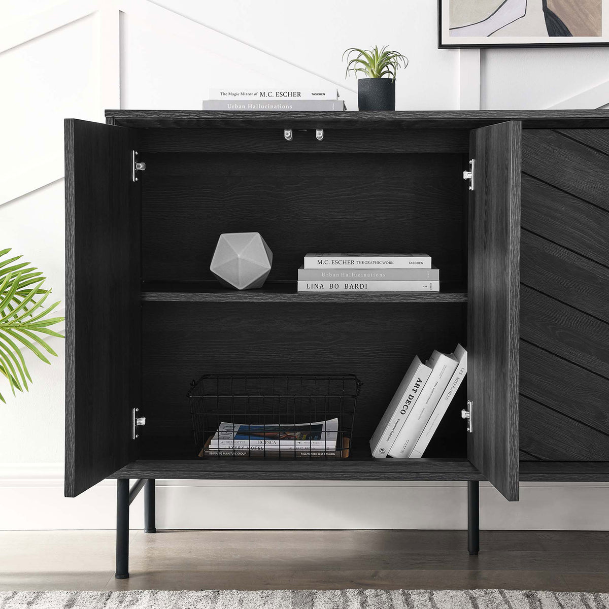 Open sideboard cabinet showing adjustable shelf with books, decor, and wire basket neatly stored || EEI-6336-BLK || storage_open_room