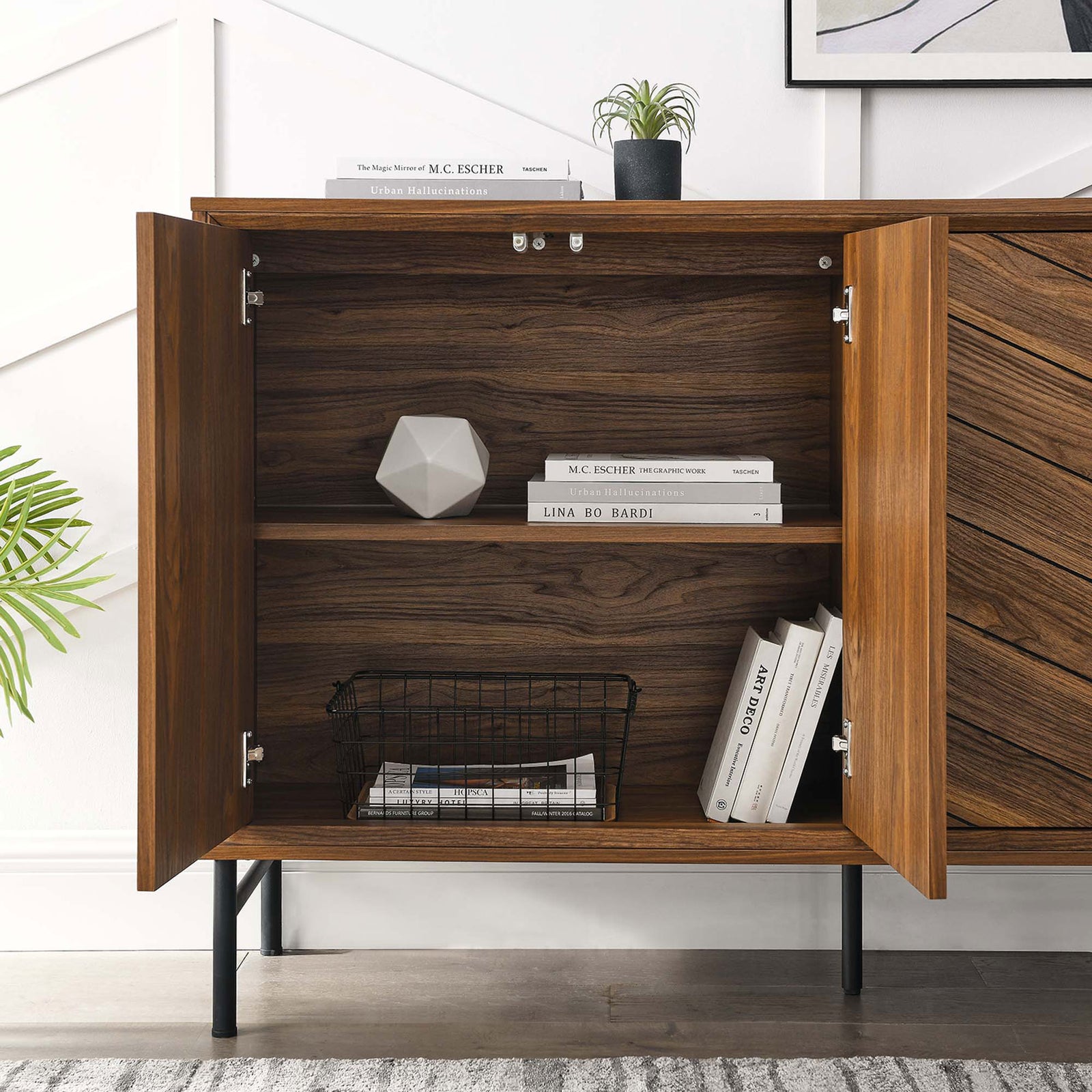 Open cabinet compartment with adjustable shelf neatly storing books, decor, and a wire basket. || EEI-6336-WAL || storage_open_room