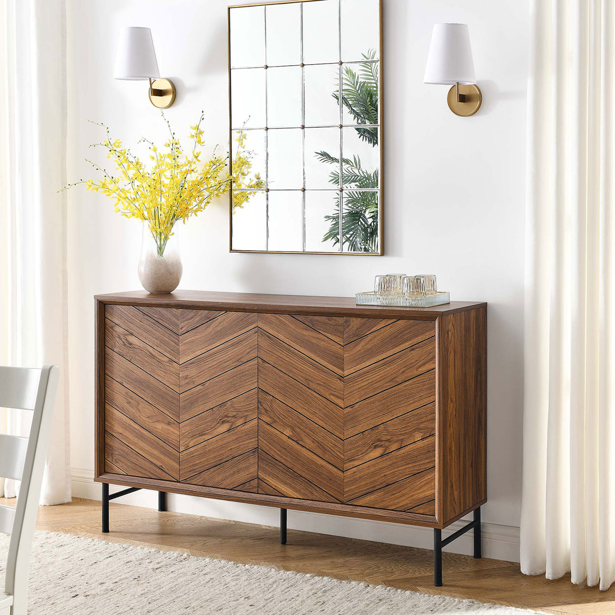 Walnut chevron sideboard styled in a bright dining room, perfect for serving drinks and decor. || EEI-6336-WAL || front_angle_room