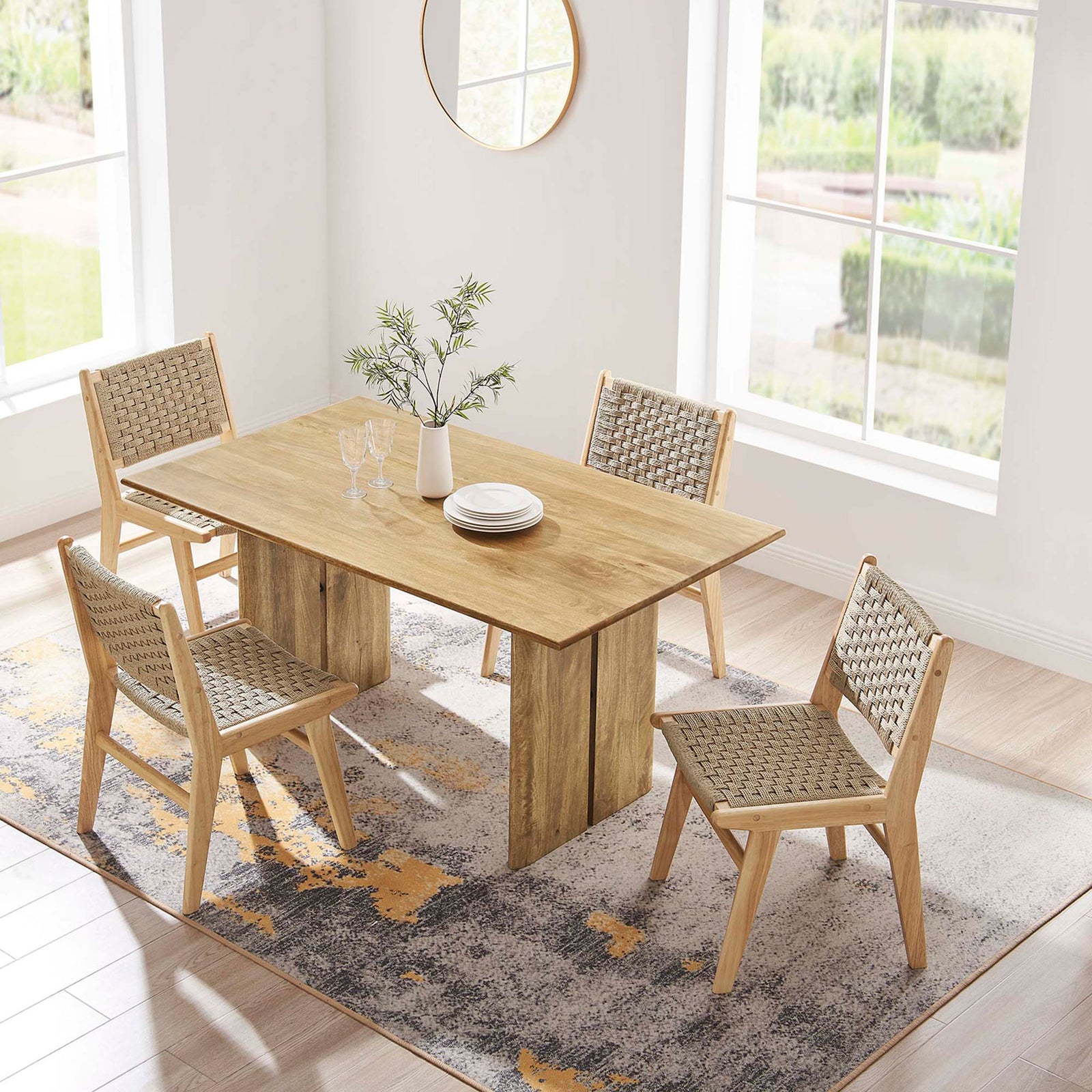 60 inch oak dining table arranged on a patterned rug with four coordinating woven chairs. || EEI-6338-OAK || top_angle_room
