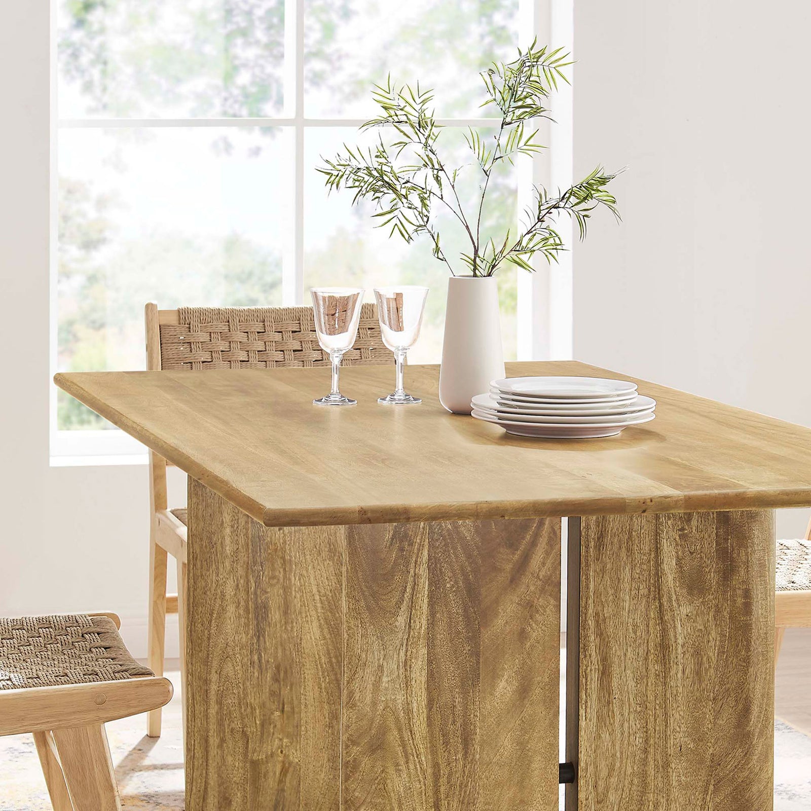 Oak dining table tabletop styled with plates, glasses, and greenery in a bright room. || EEI-6338-OAK || detail_room