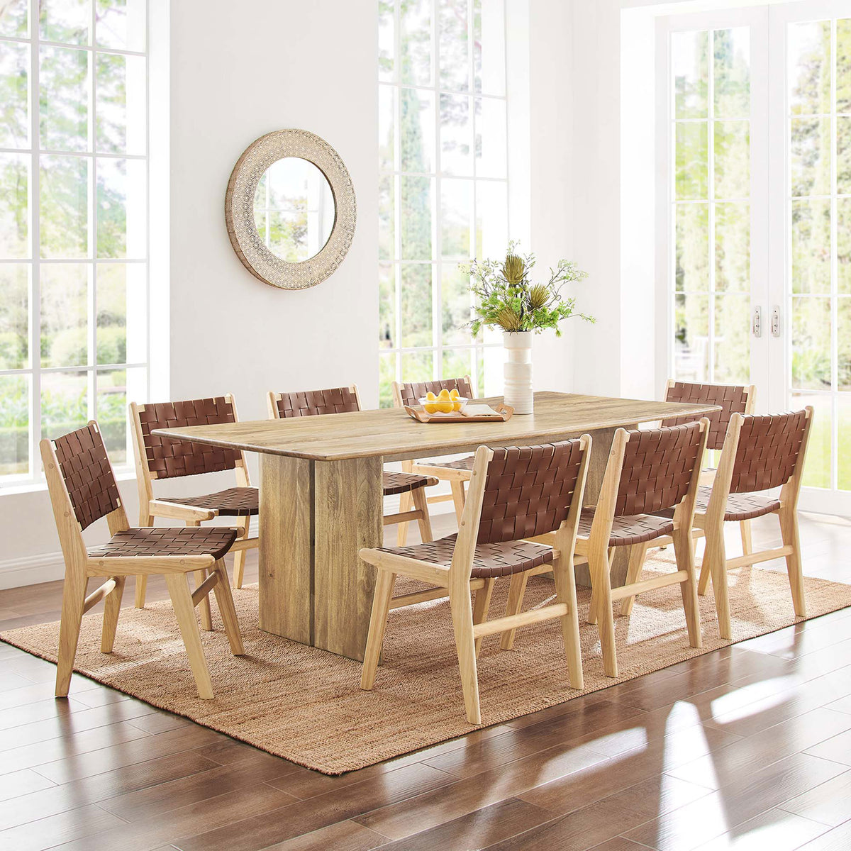 86 inch oak dining table styled with eight woven chairs in a sunny, open dining room. || EEI-6340-OAK || front_angle_room