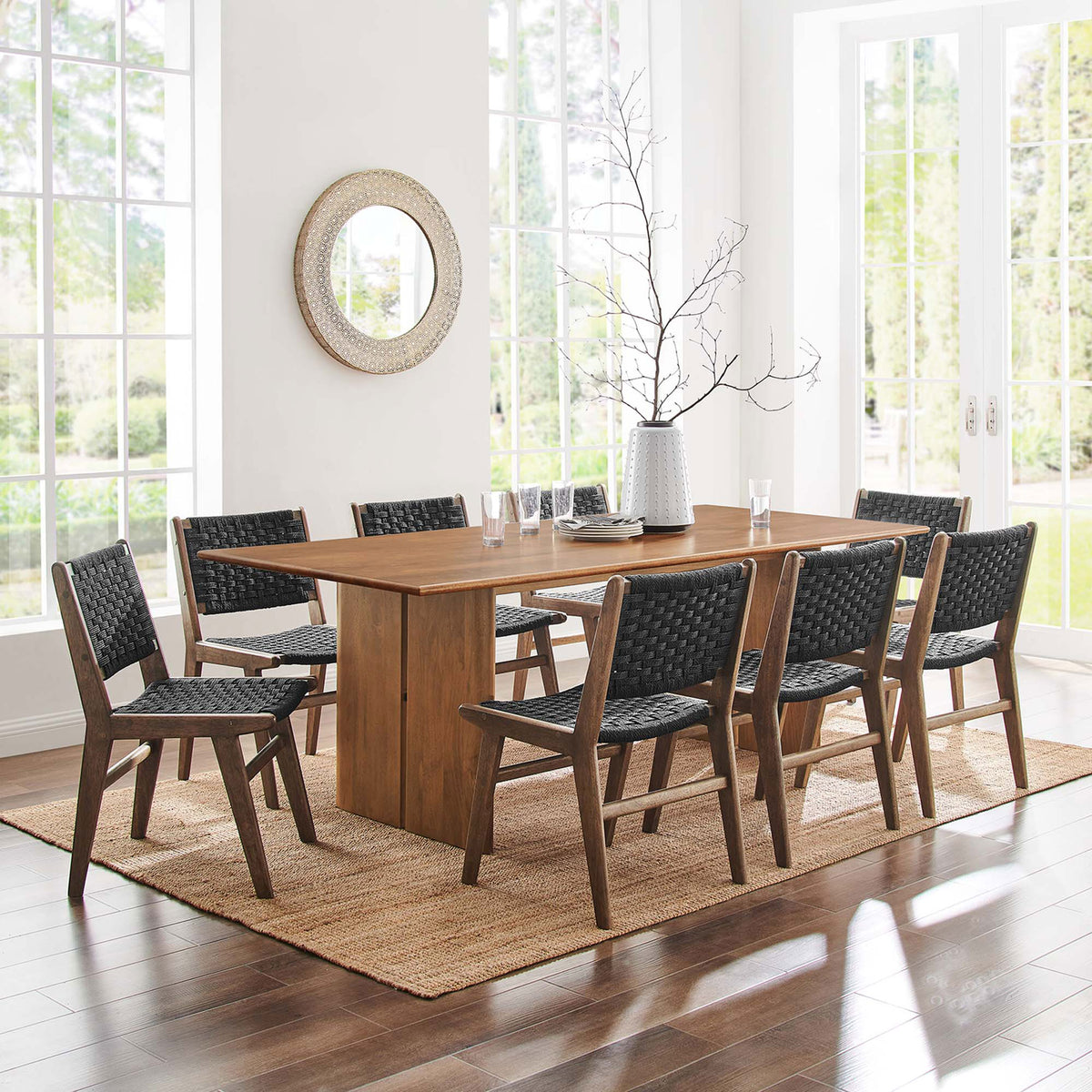 Amistad 86 inch dining table set with eight black woven chairs in a sunlit dining space || EEI-6340-WAL || front_room