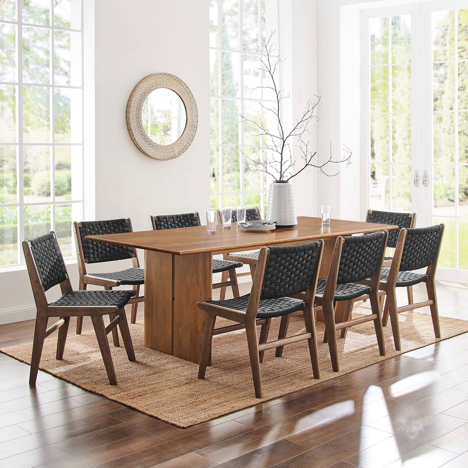 Amistad 86 inch dining table set with eight black woven chairs in a sunlit dining space || EEI-6340-WAL || front_room