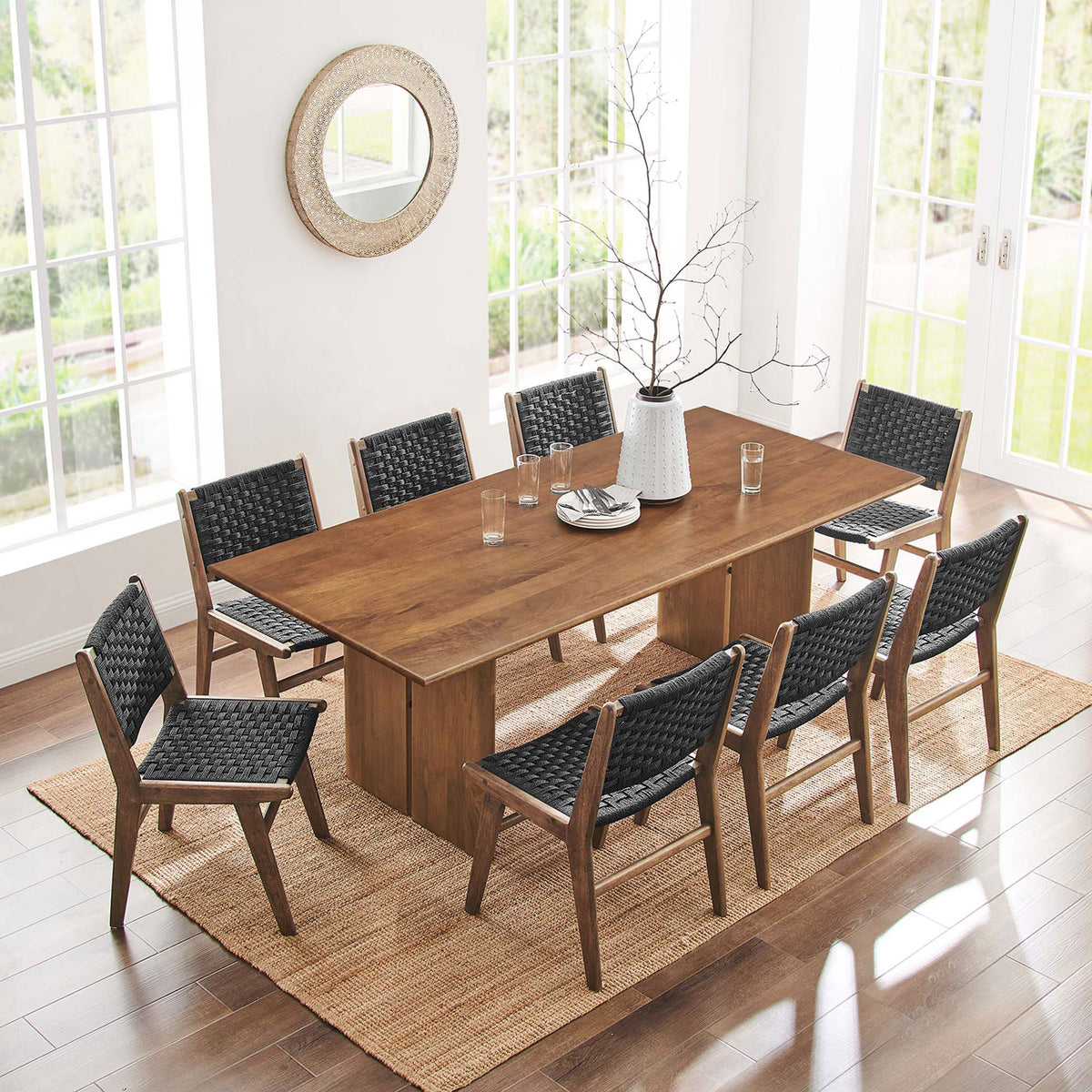Spacious dining setting with the 86 inch Amistad table centered on a jute rug with eight chairs || EEI-6340-WAL || top_angle_room