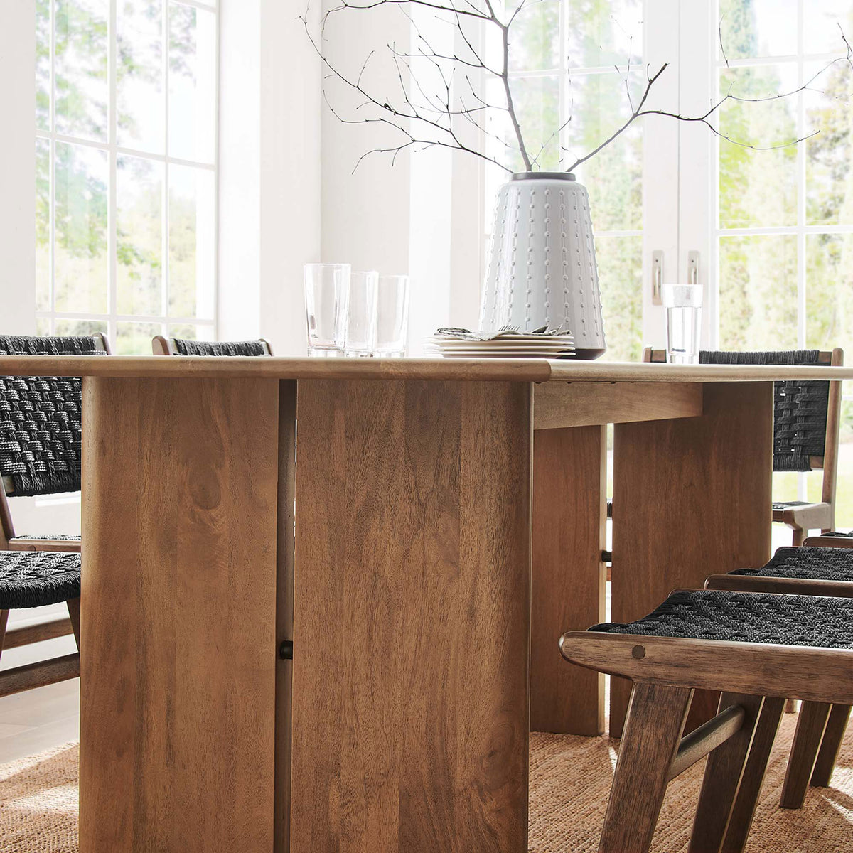 Amistad table edge and legs styled with glassware and black woven dining chairs || EEI-6340-WAL || detail_room