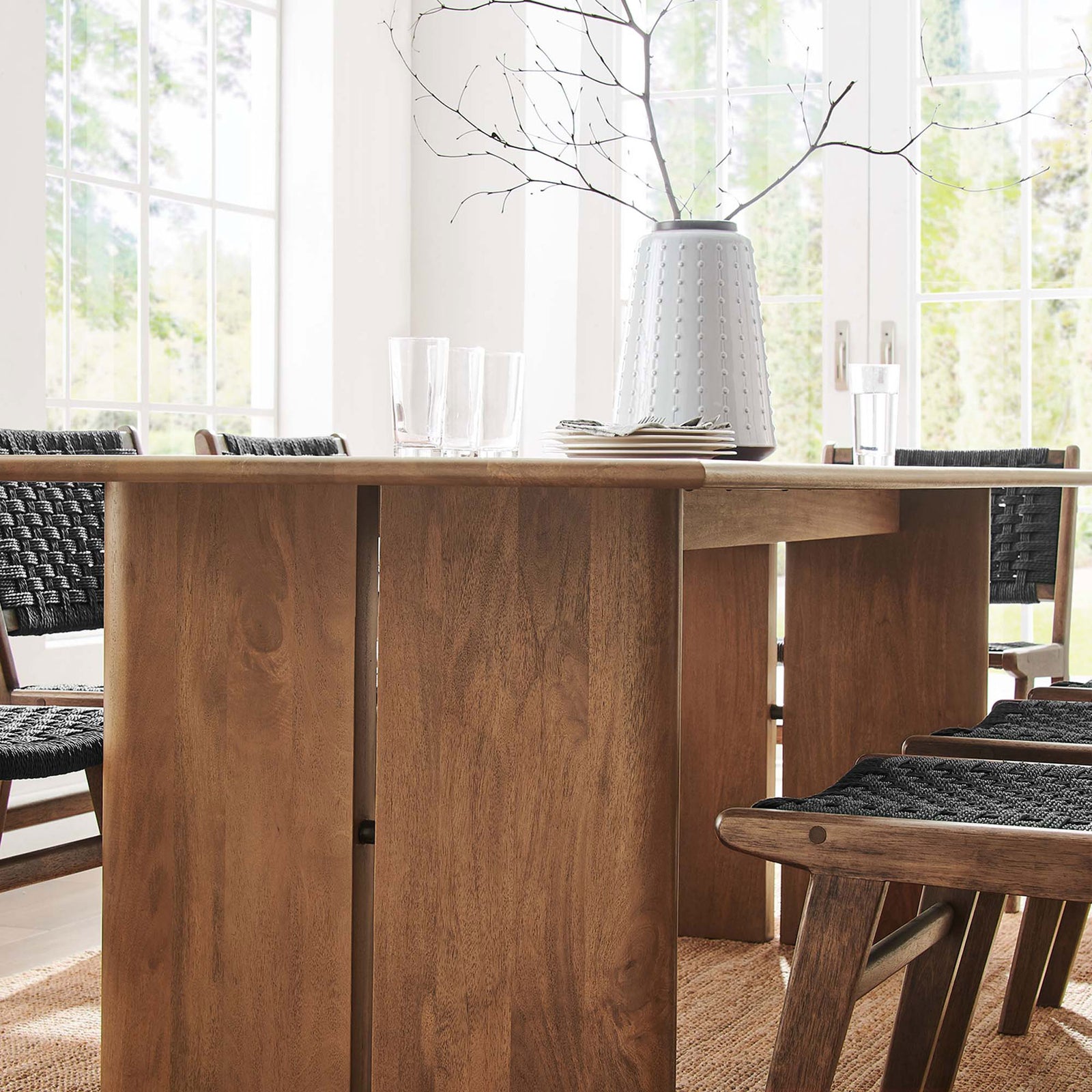 Amistad table edge and legs styled with glassware and black woven dining chairs || EEI-6340-WAL || detail_room