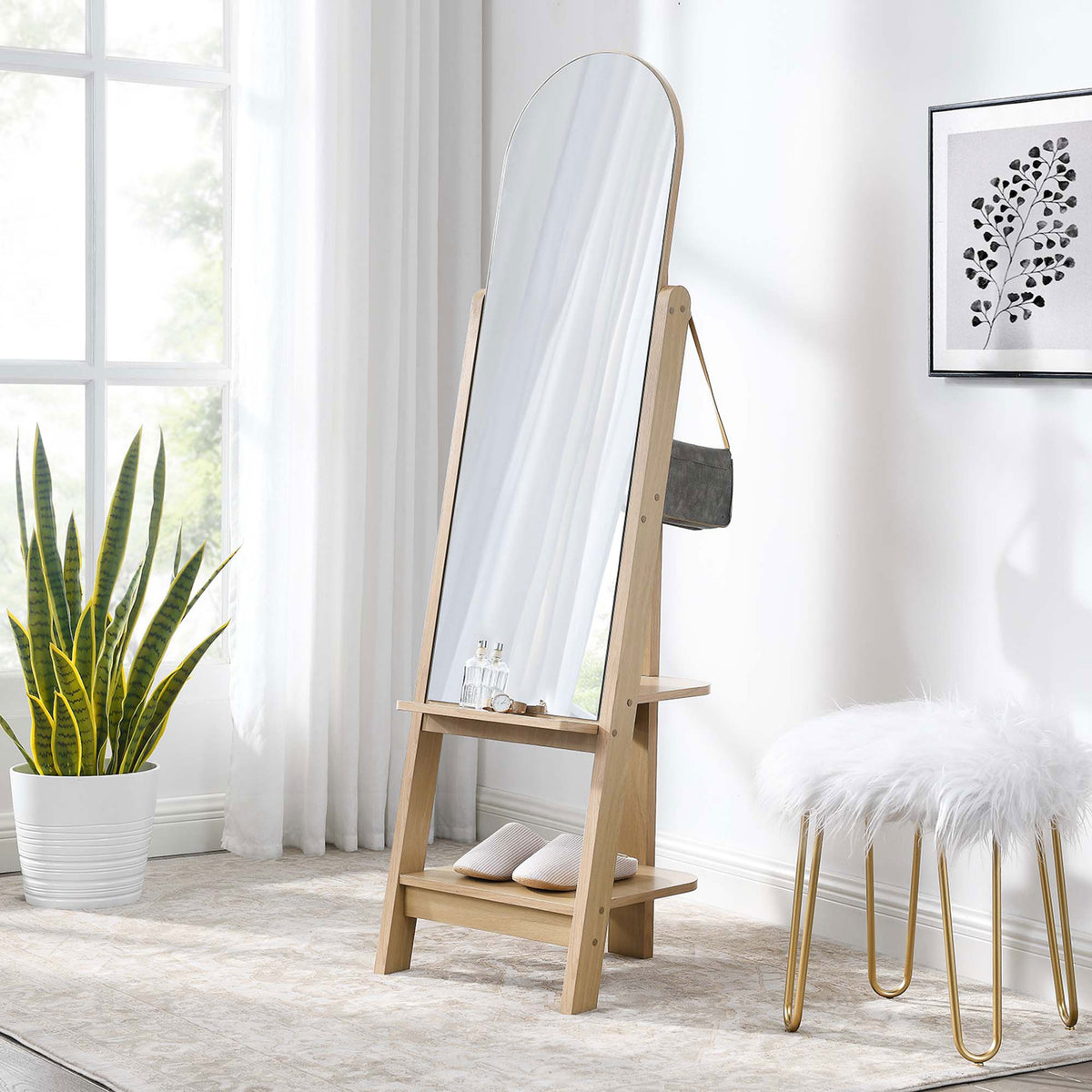 Ascend oak standing mirror in a cozy bedroom with layered rug, stool, and greenery || EEI-6346-OAK || front_angle_room