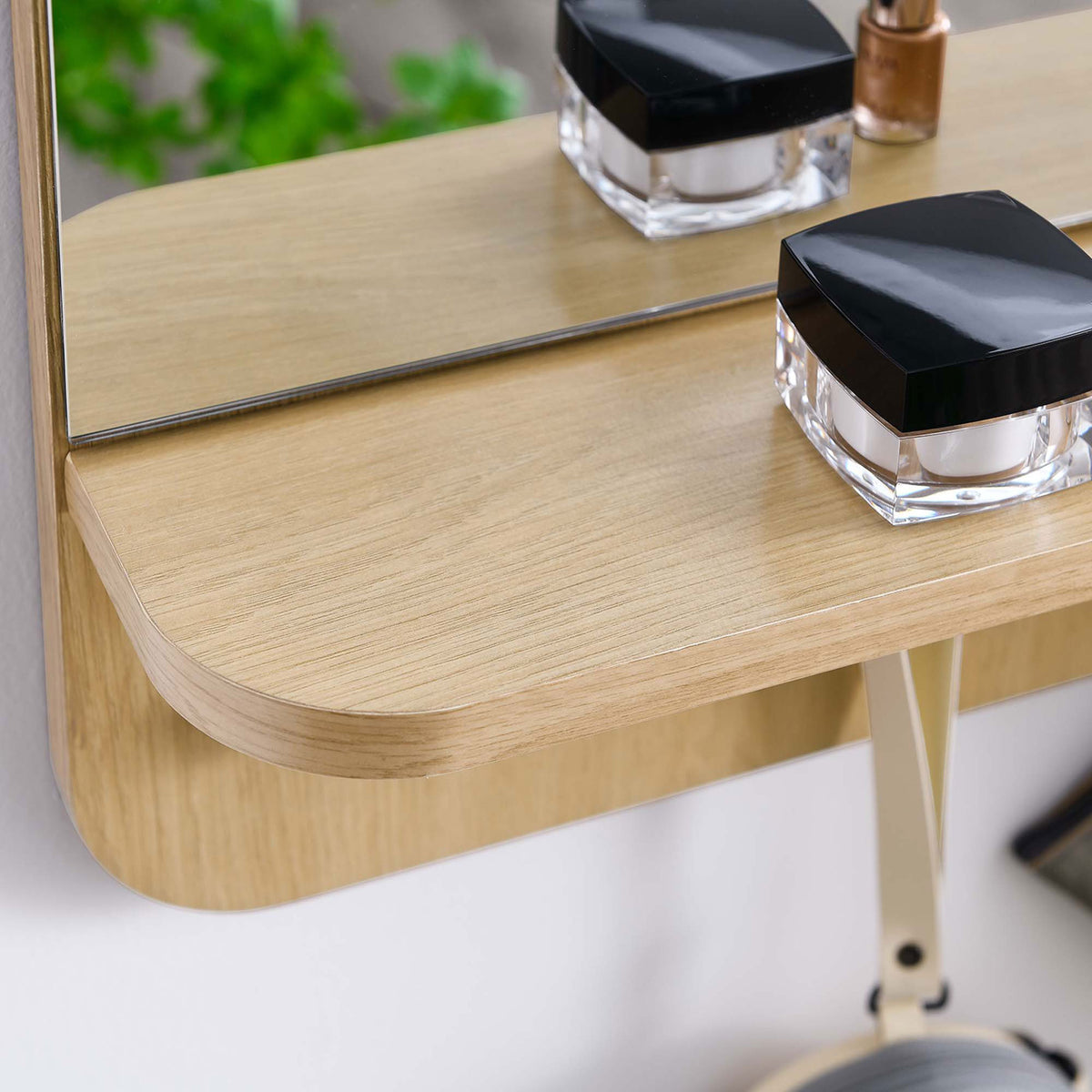 Oak Lumina mirror shelf holding beauty essentials, showing the smooth wood grain and mirror edge || EEI-6348-OAK || detail_room
