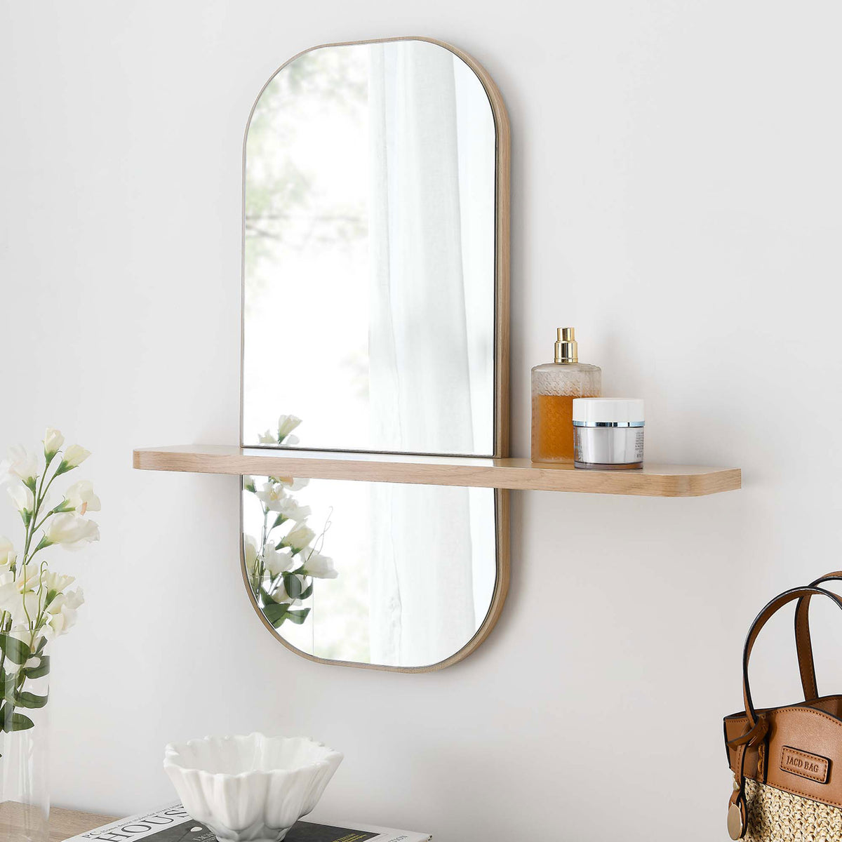 Oak wall mirror with shelf styled above a console, perfect for entryways or vanity spaces. || EEI-6349-OAK || front_angle_room