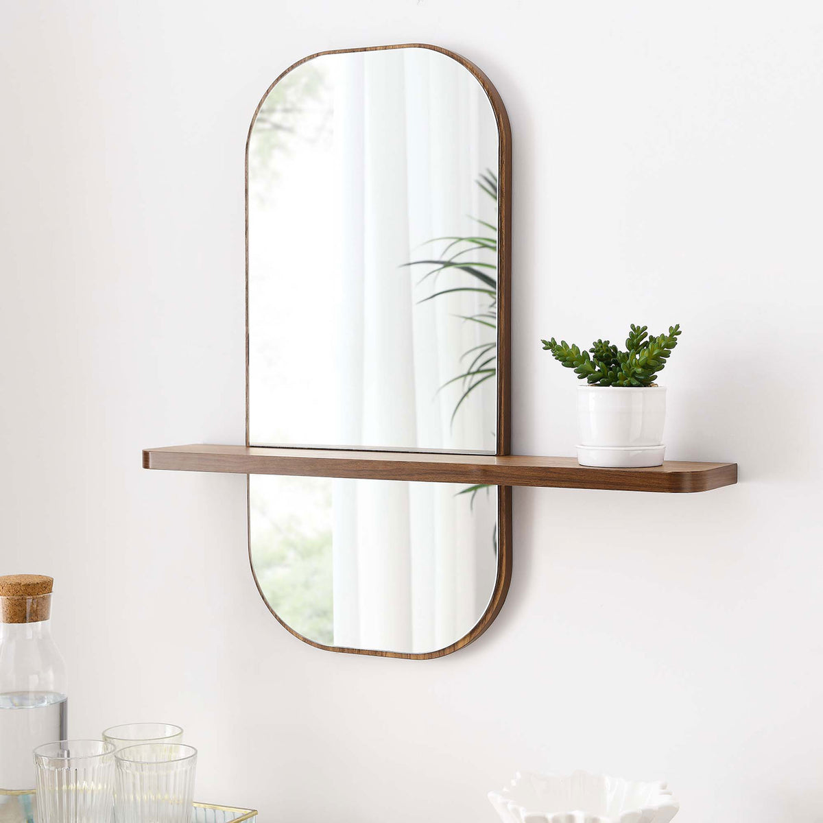 Walnut wall mirror with shelf styled with greenery and glassware for a fresh modern look. || EEI-6349-WAL || front_angle_room