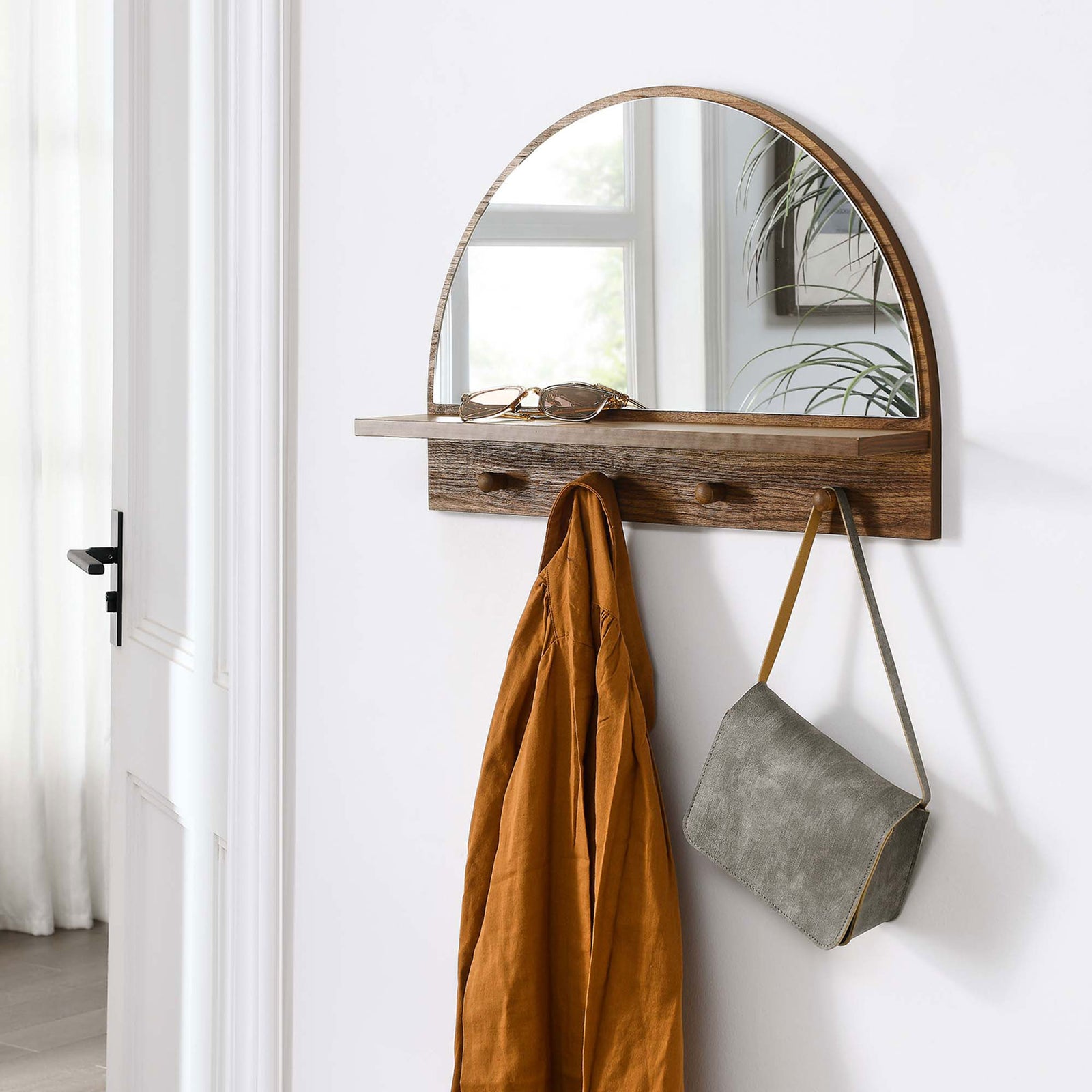 Wall-mounted Moonbeam walnut arched mirror creates a welcoming, organized entryway drop zone || EEI-6350-WAL || front_angle_room