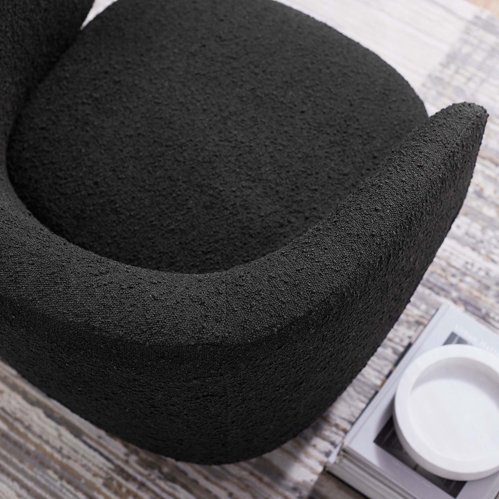 Textured boucle and contoured wraparound arm create a soft, tactile feel. || EEI-6357-BLK || detail_room