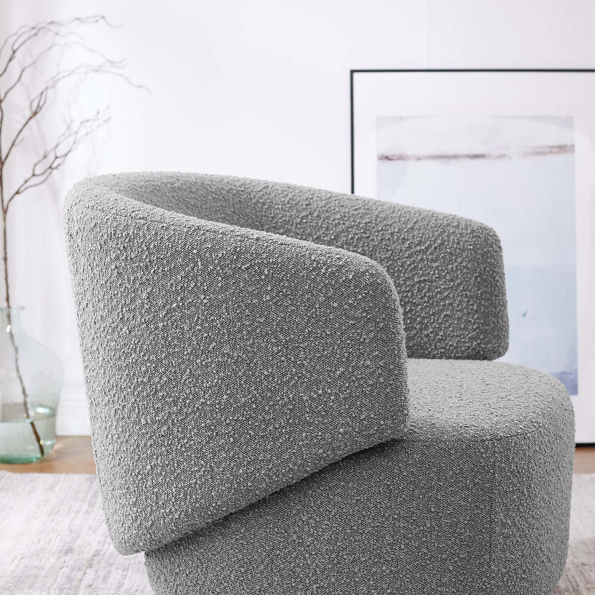Nubby boucle texture and sculpted arm detail add dimension to this modern swivel chair || EEI-6357-LGR || detail_room