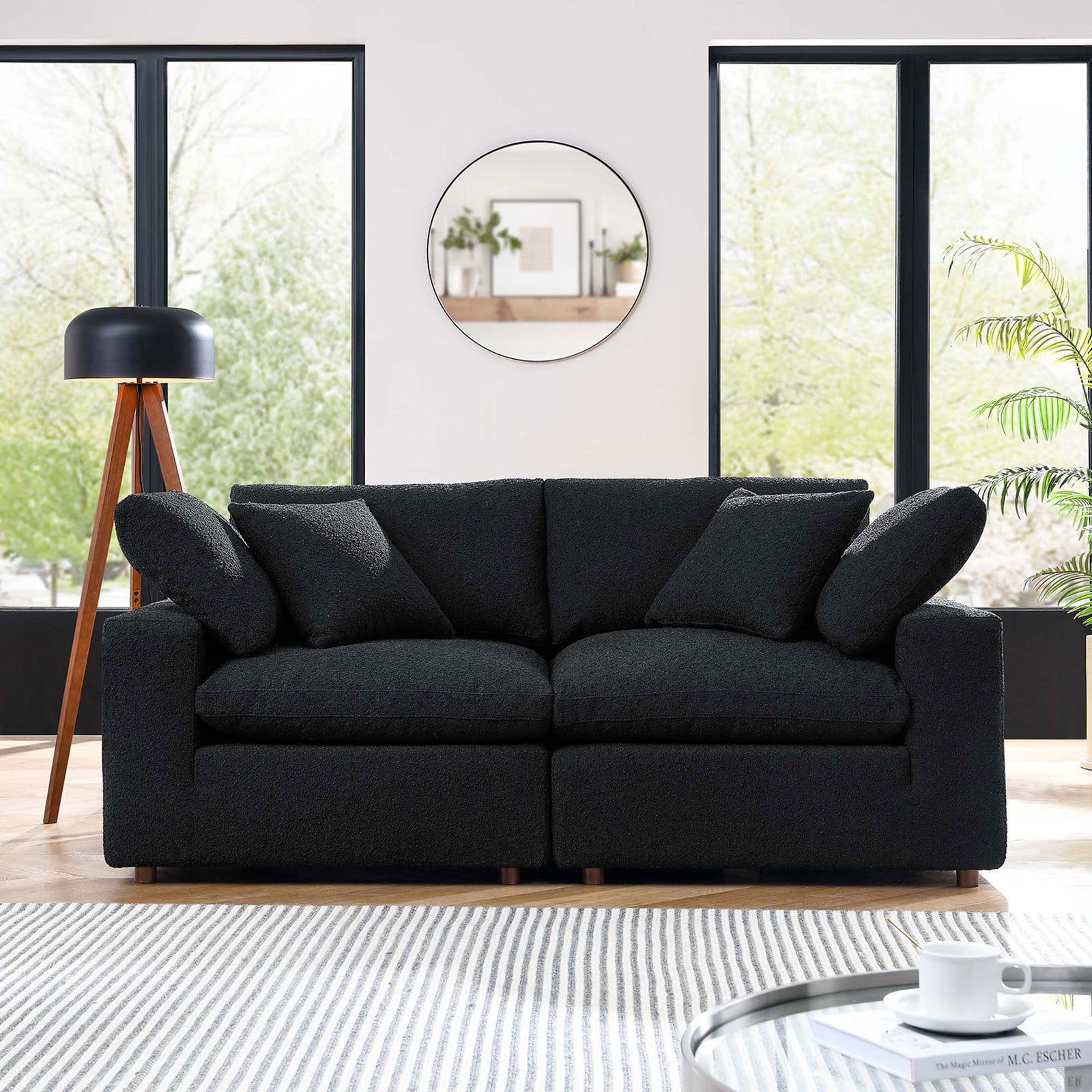Black boucle loveseat with plush loose cushions centered in a contemporary living room. || EEI-6361-BLK || front_room