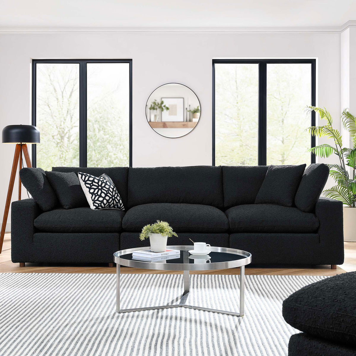 Black boucle three seat sofa styled in a bright modern living room with patterned pillow and round glass table || EEI-6362-BLK || front_room