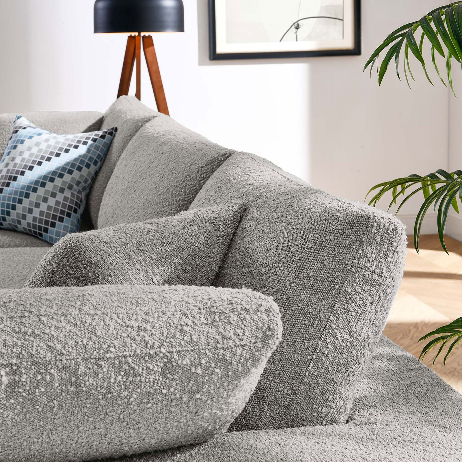 Cozy corner of light gray boucle sofa showing textured cushions styled with modern lamp and wall art || EEI-6362-LGR || detail_room