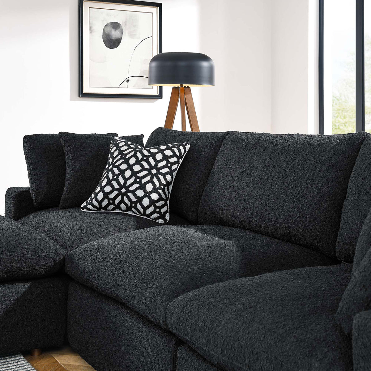 Black boucle sectional sofa cushions with patterned accent pillow in a bright room || EEI-6363-BLK || detail_room