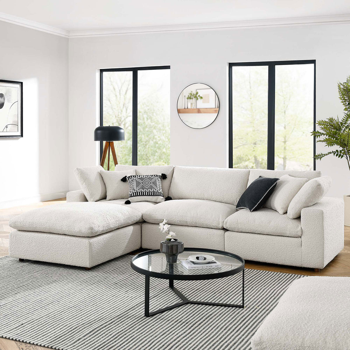 Ivory boucle sectional arranged in a bright living room with modern decor, rug, and round coffee table || EEI-6363-IVO || front_room