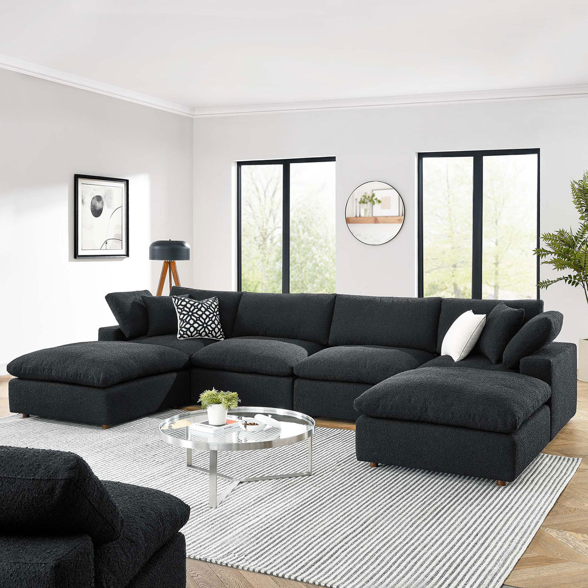 Black boucle Commix sectional styled in a bright living room with layered pillows and a modern round coffee table || EEI-6366-BLK || front_angle_room
